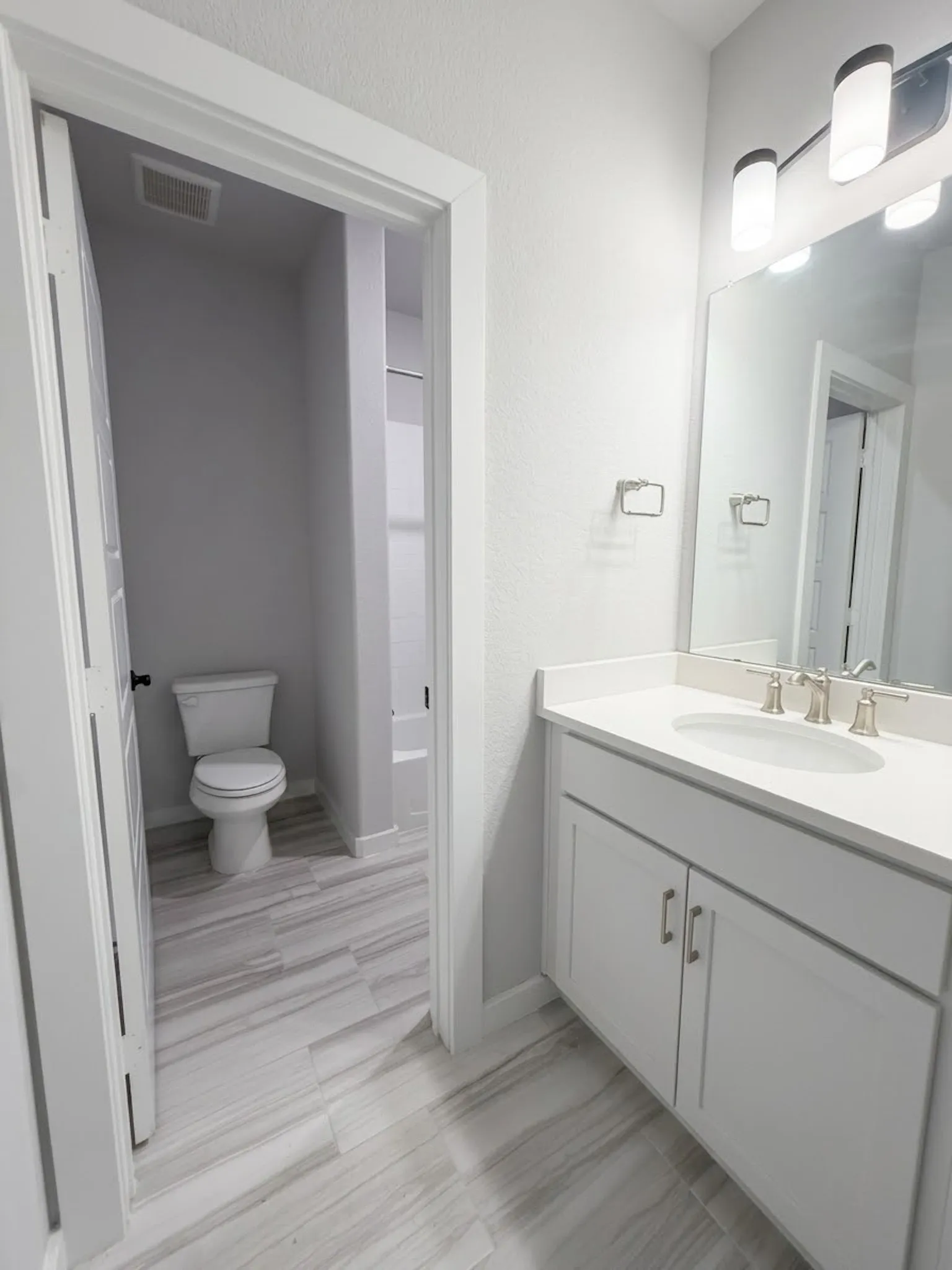 Upstairs jack and jill bathroom with separate counters