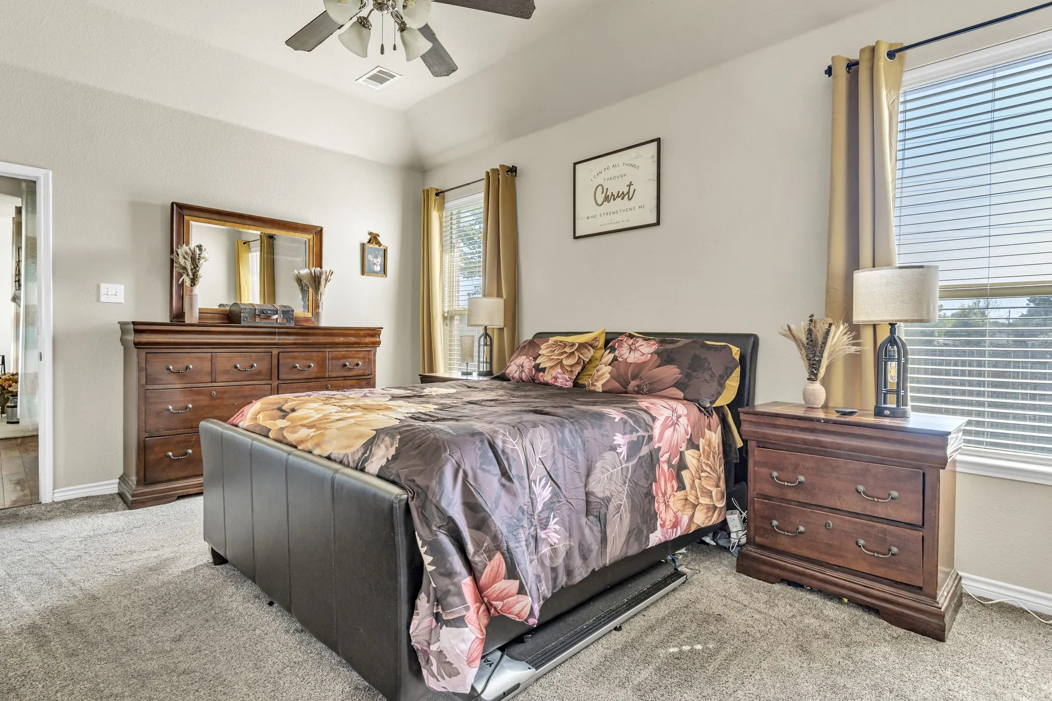 Vaulted ceiling with a ceiling fan, neutral wall tones, carpeted flooring, and a window with blinds