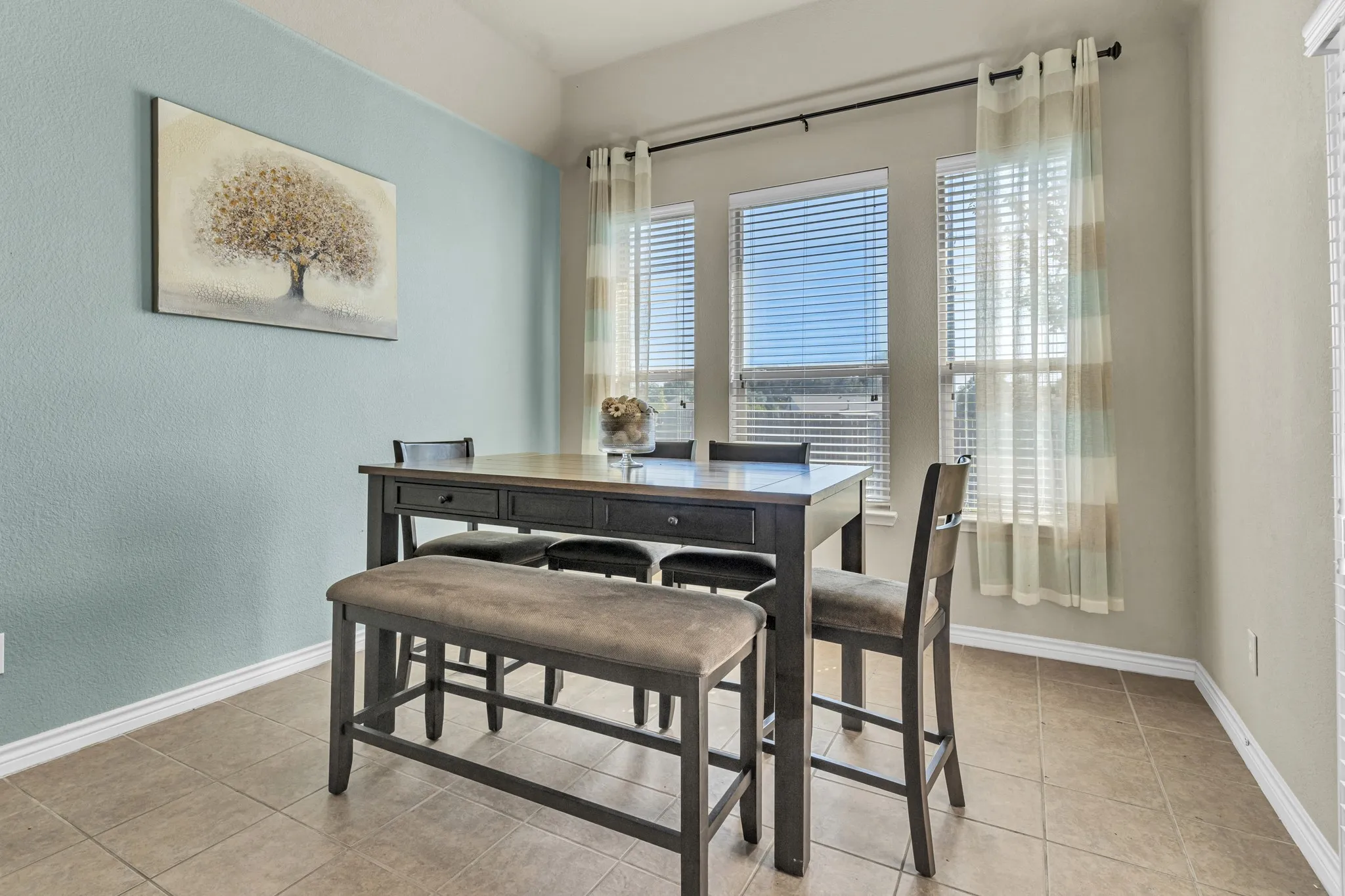 Recessed ceiling lights, tile flooring, and multiple windows with blinds
