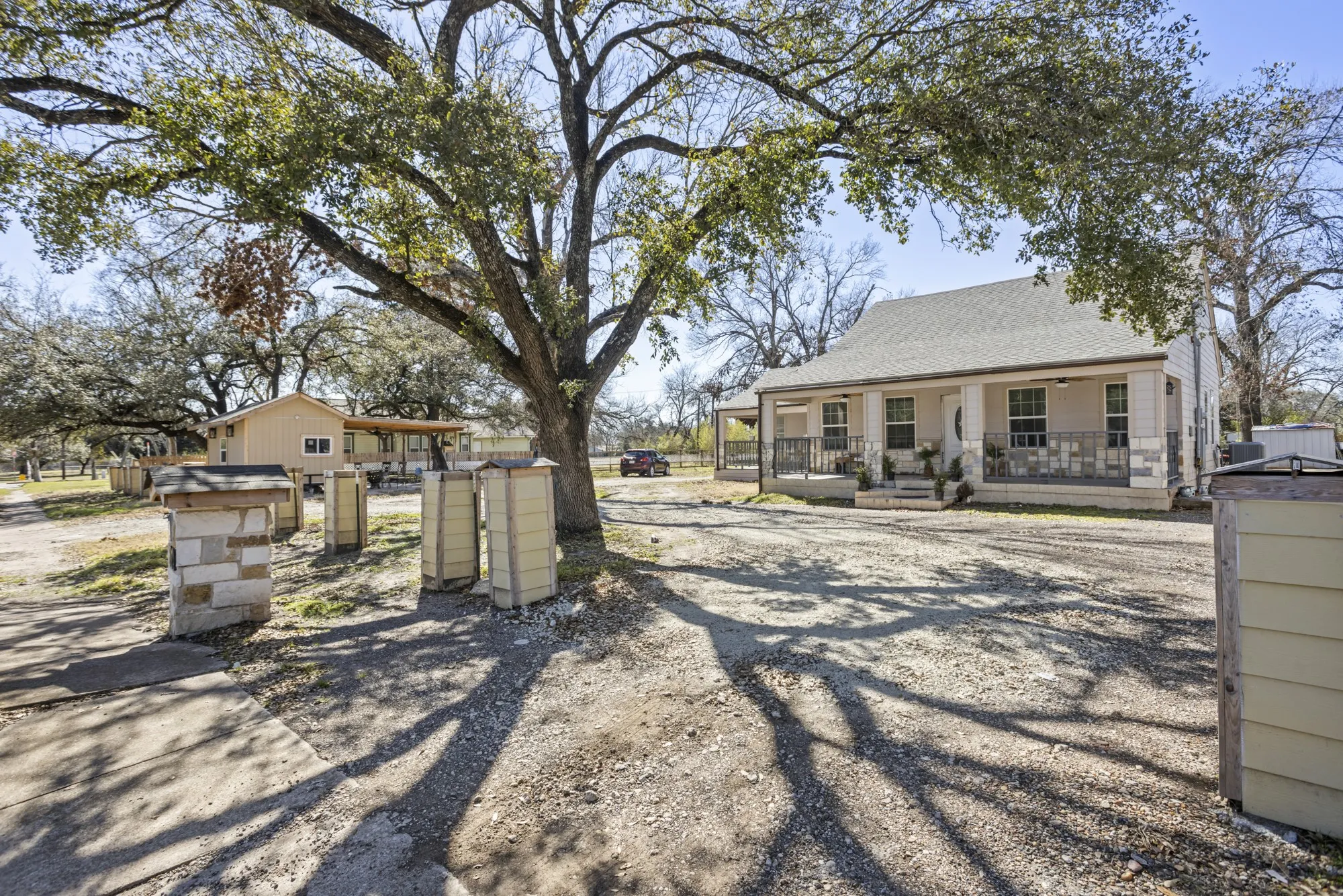 Back of property with a shingled roof and covered porch