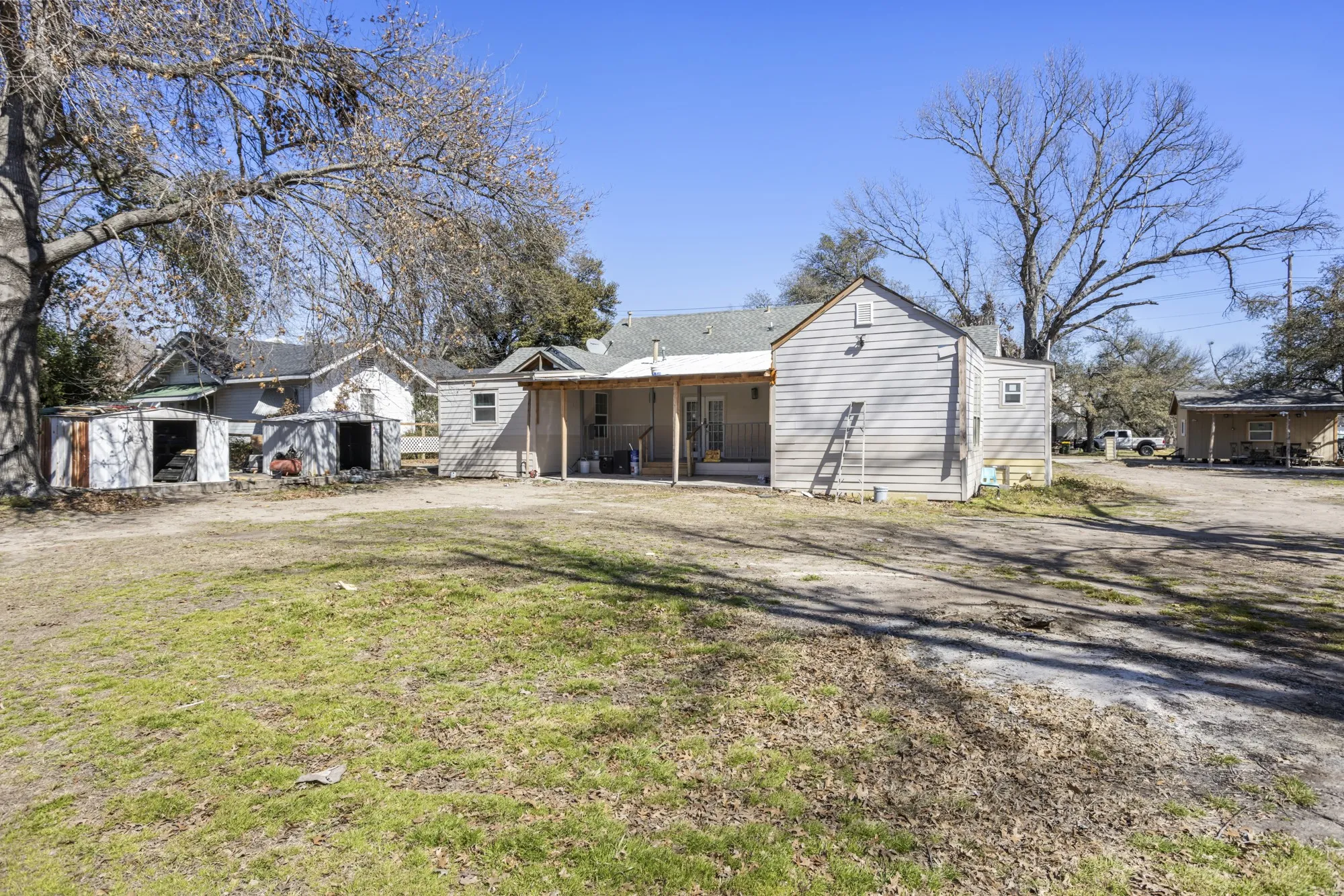Rear view of property with a yard