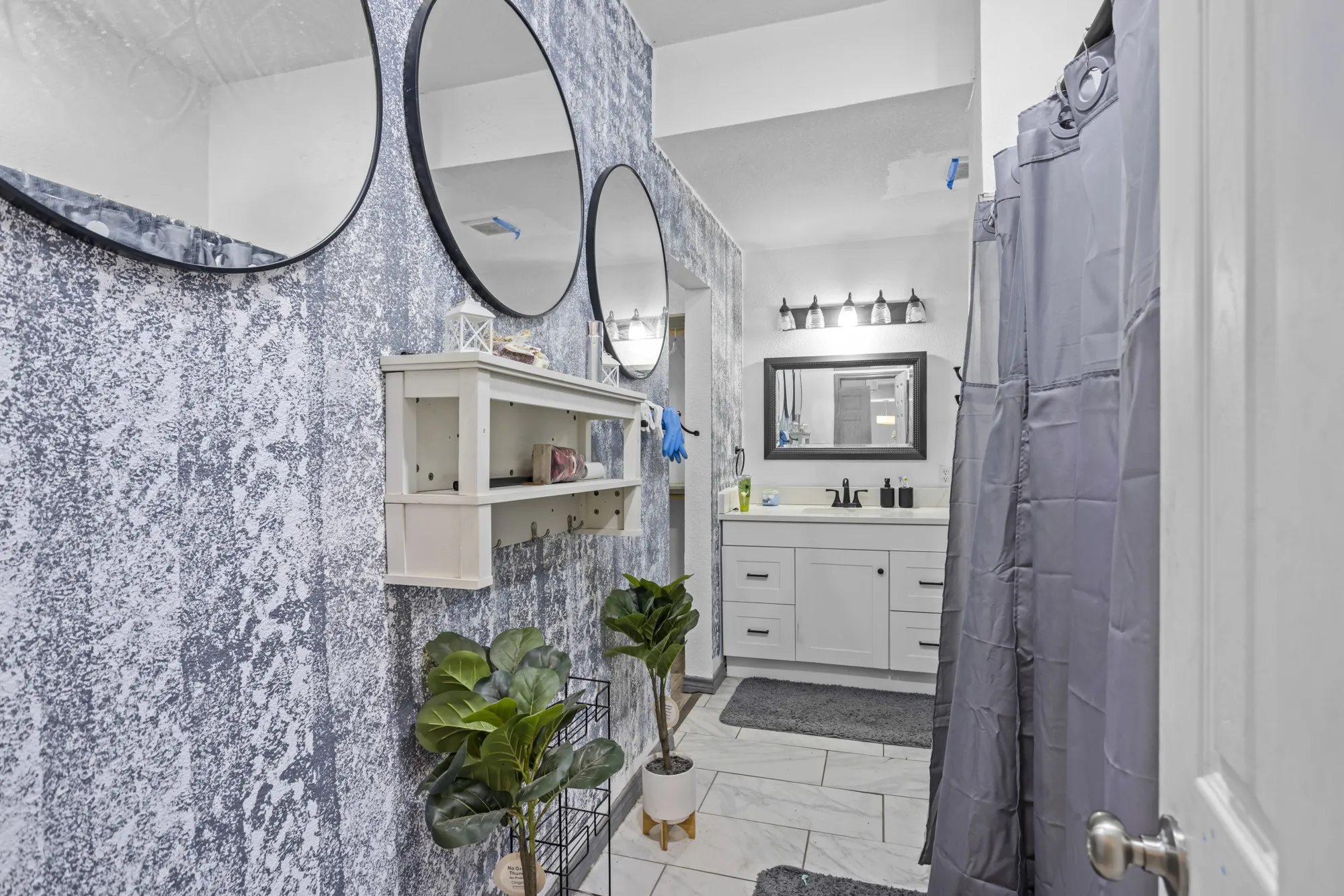 Bathroom with vanity and marble finish floors