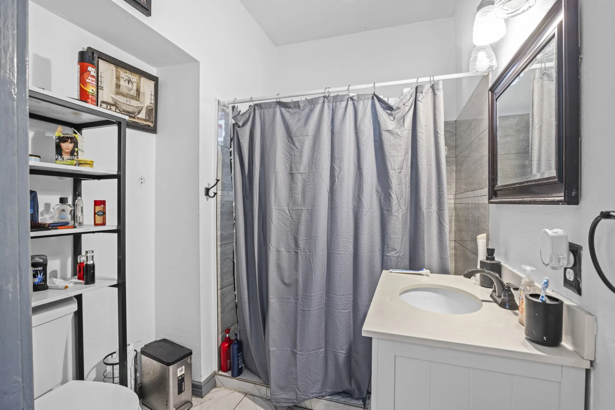 Full bath with vanity and a shower with shower curtain