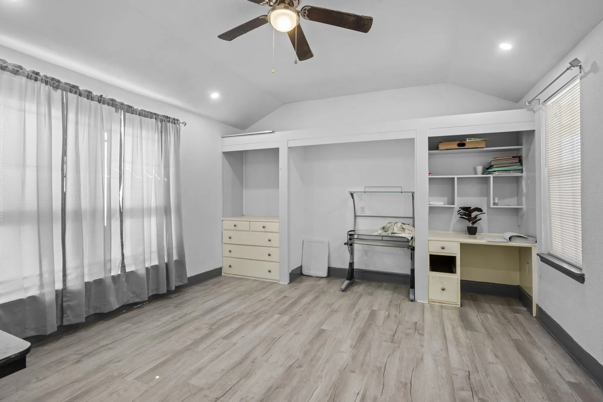 Office/bedroom with plenty of natural light, vaulted ceiling, recessed lighting, a ceiling fan, and light wood-type flooring