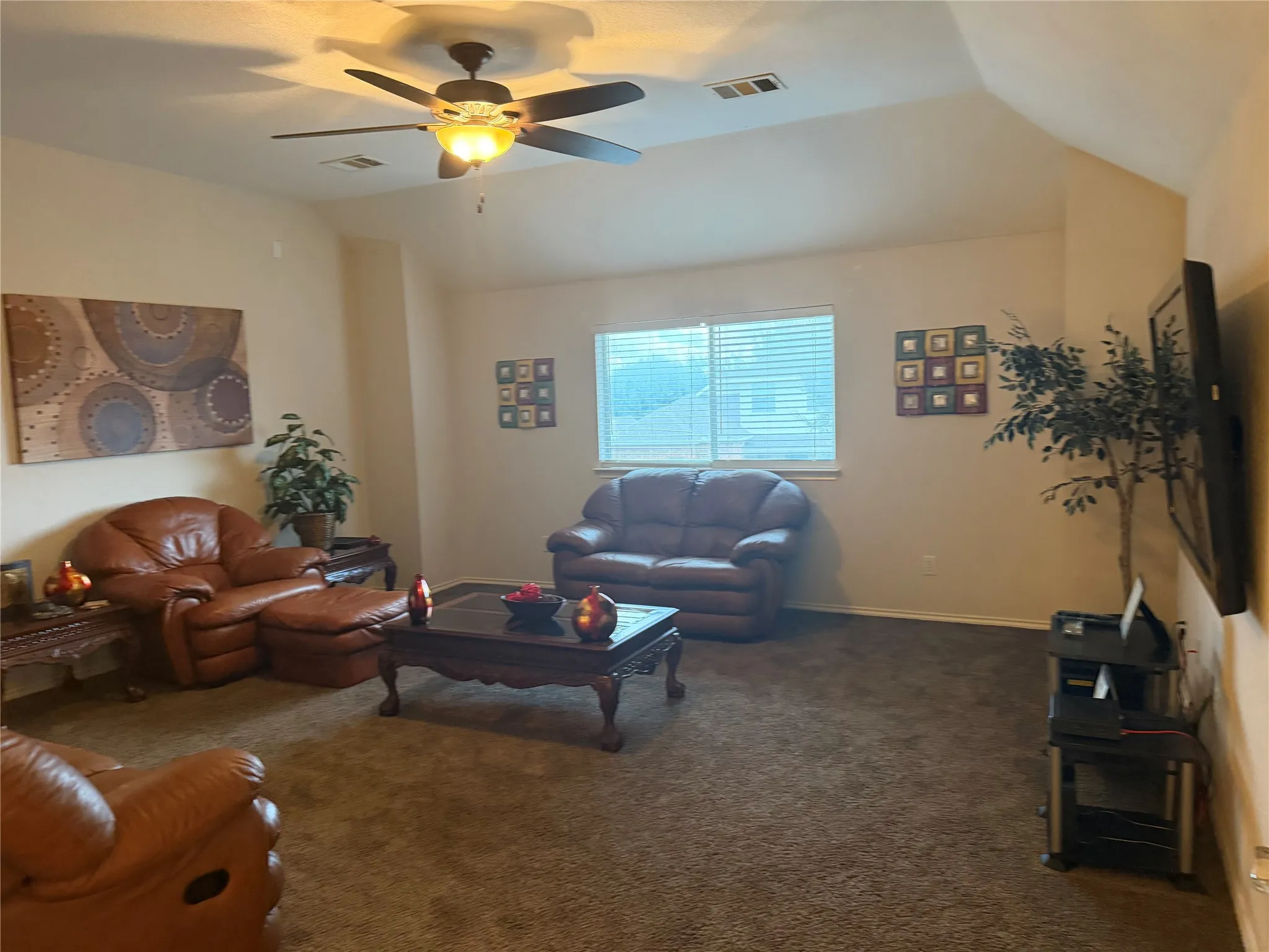 Recessed window with horizontal blinds, sloped ceiling, and ceiling fan with integrated lighting