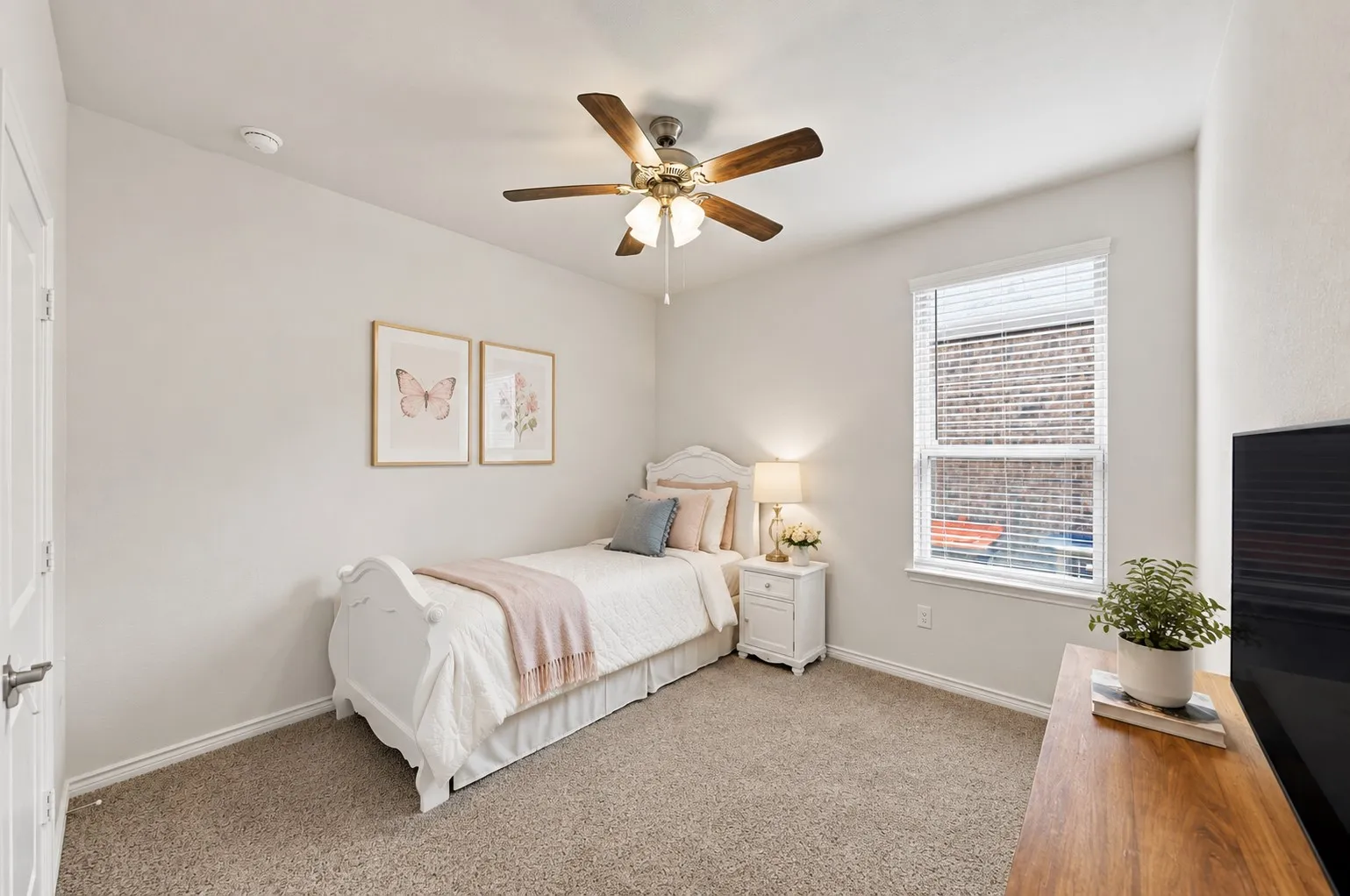 Carpeted flooring, a window with blinds, a ceiling fan with integrated lighting, and a white interior door