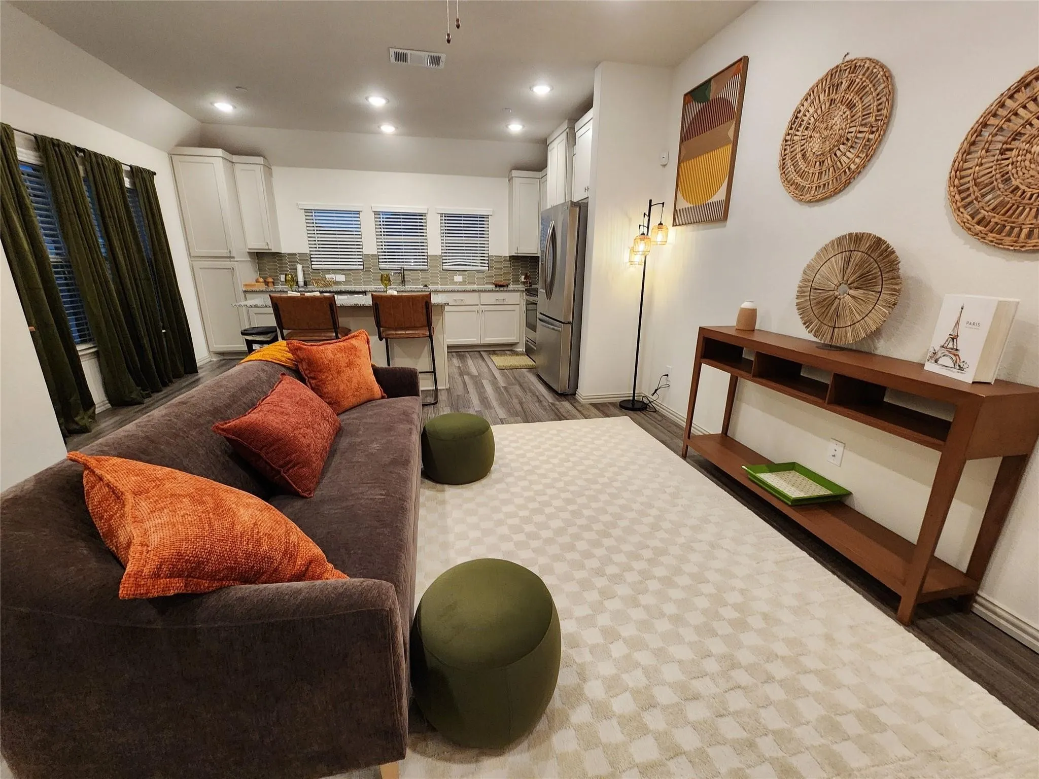 Open-concept living area featuring wood-finish flooring