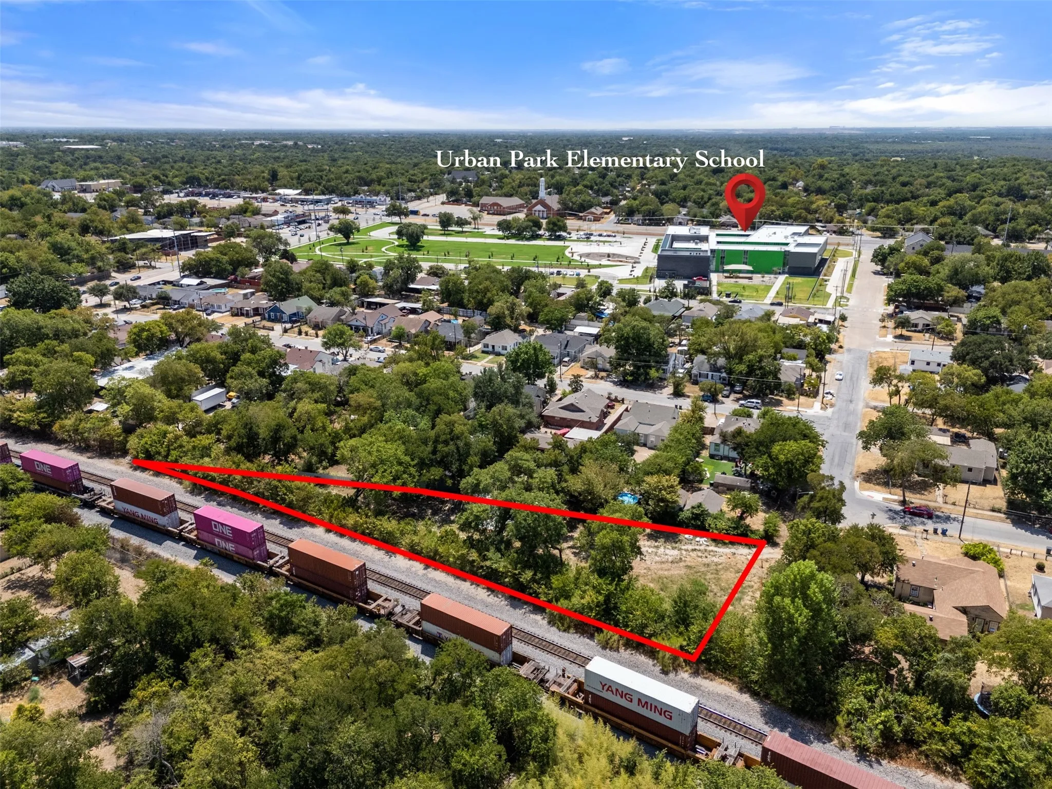Expansive lot with mature trees, offering significant development potential, with convenient access to Urban Park Elementary School