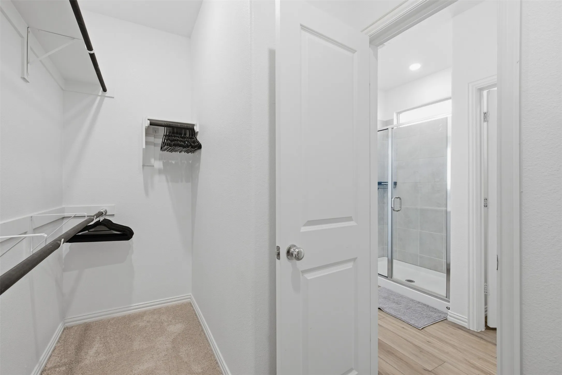 Large walk-in primary closet featuring built in cabinets (not pictured)