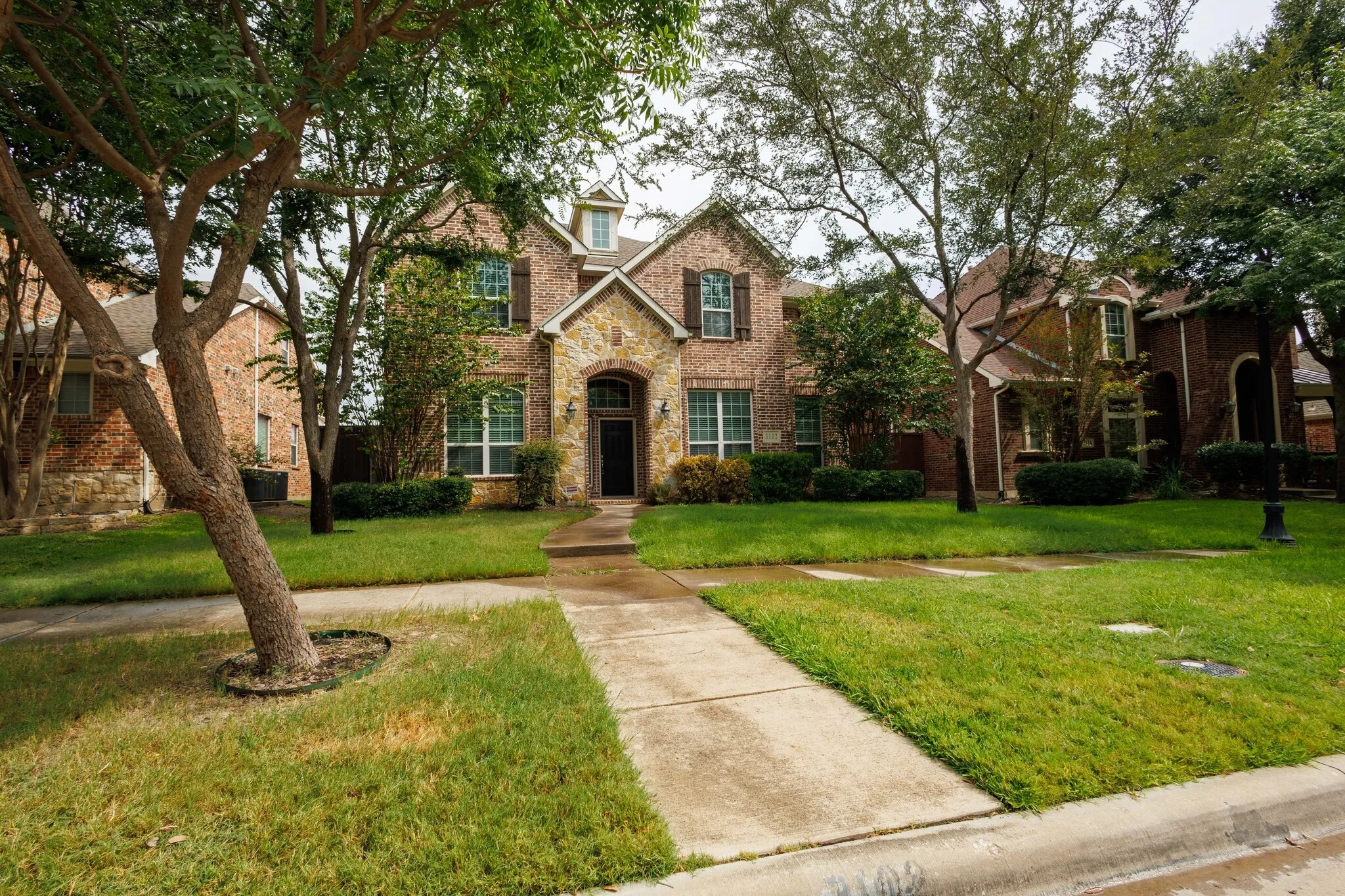 Brick and stone facade with decorative shutters