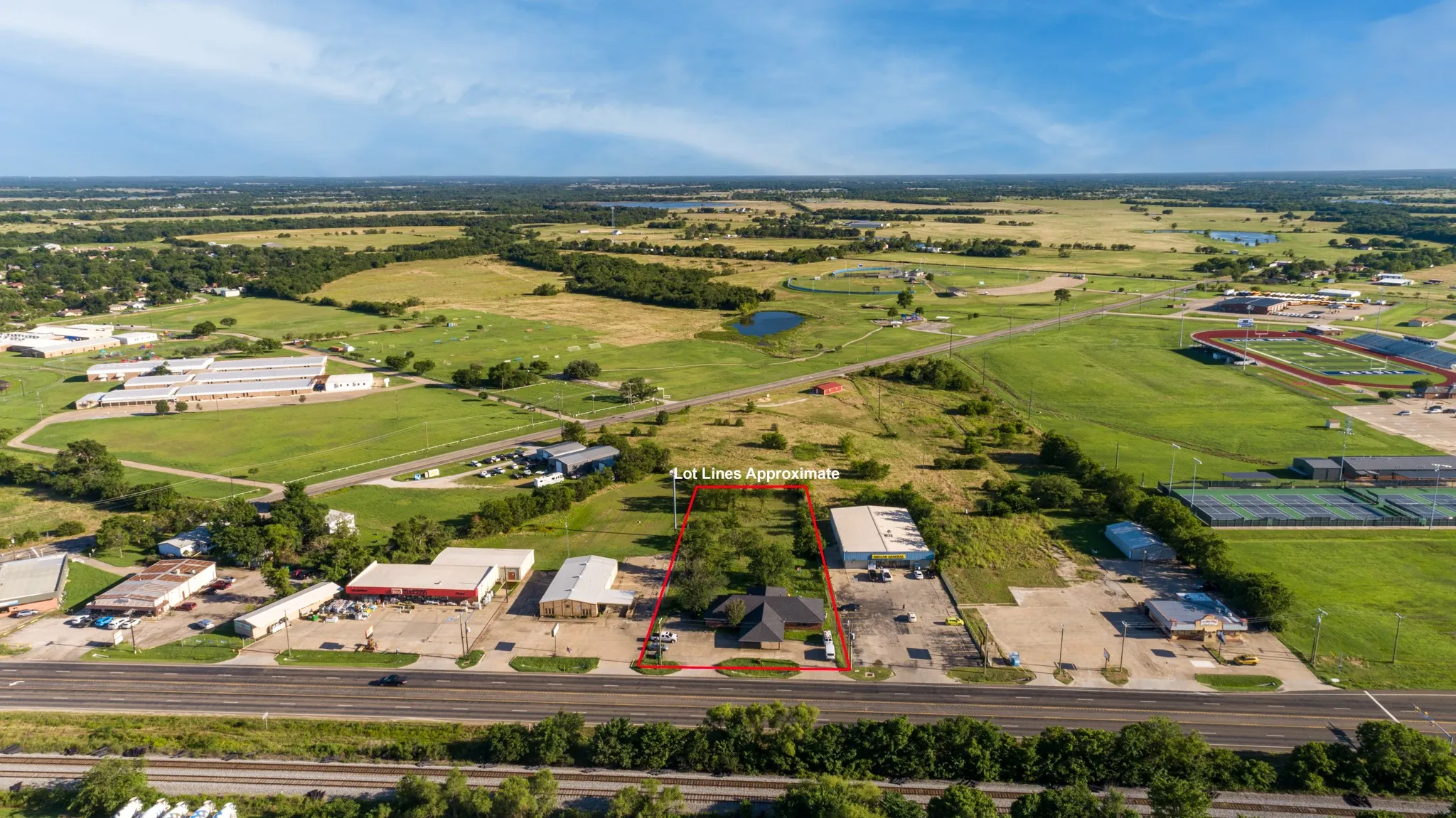 Property situated on a paved thoroughfare with multiple commercial structures