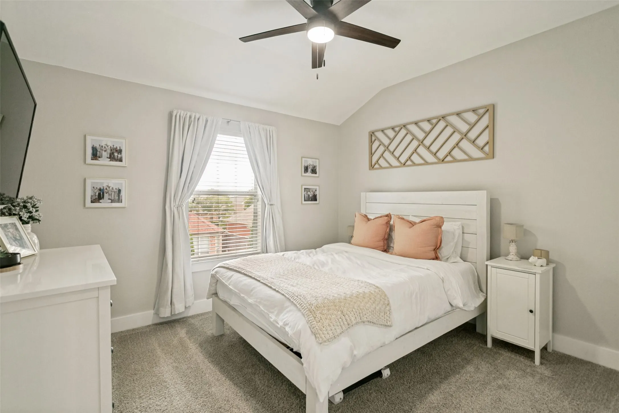 Carpeted room featuring a ceiling fan with integrated lighting, a window with blinds, and light gray wall finishes