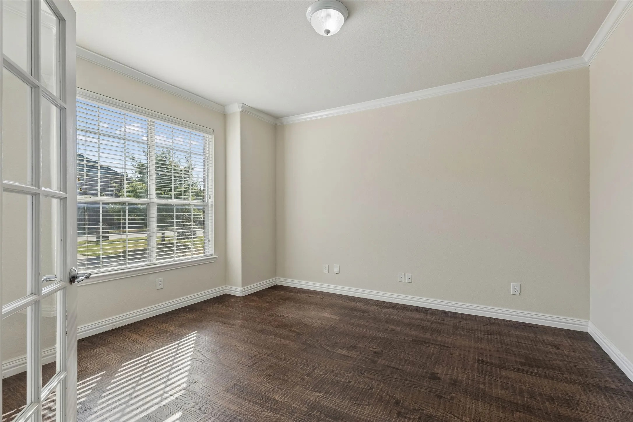 Wood-finish flooring with crisp white baseboards