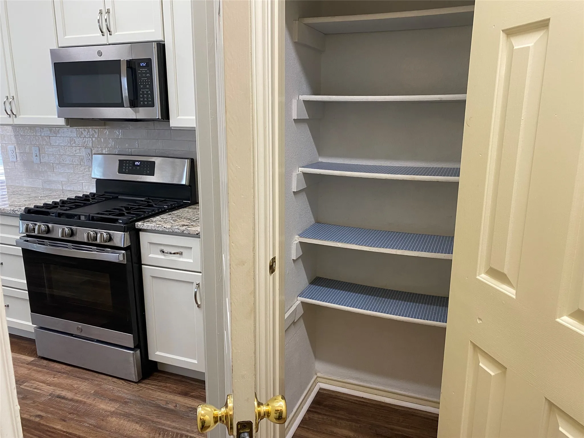 Pantry is behind kitchen door in utility