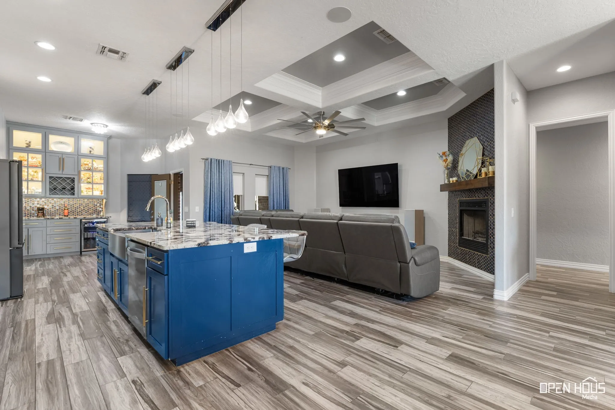 Tile flooring, recessed lighting, and a tray ceiling with a ceiling fan