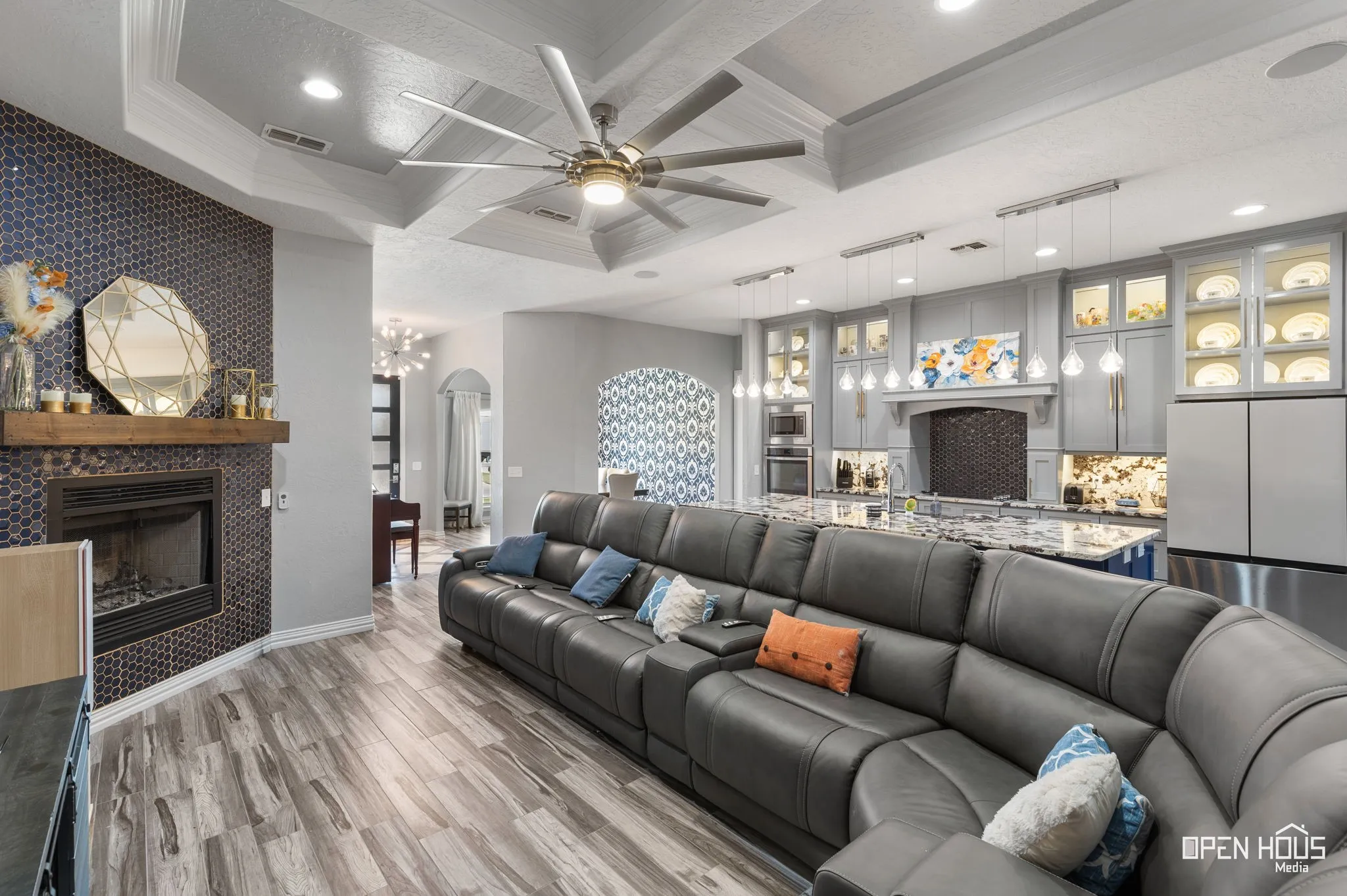 Tray ceilings with a contemporary ceiling fan, recessed lighting, and tile flooring