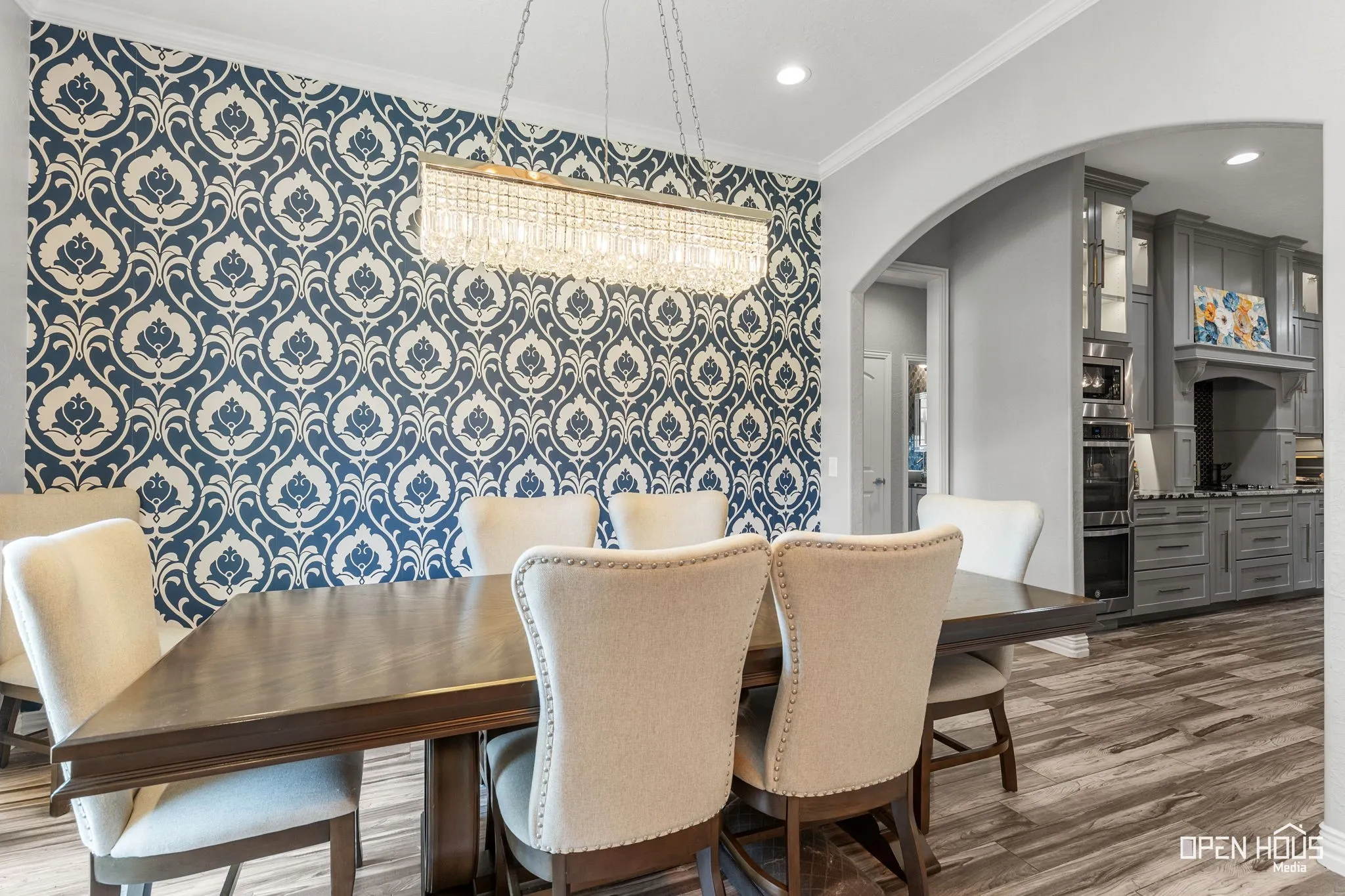 Recessed lighting, crown molding, tile flooring, and an arched entry