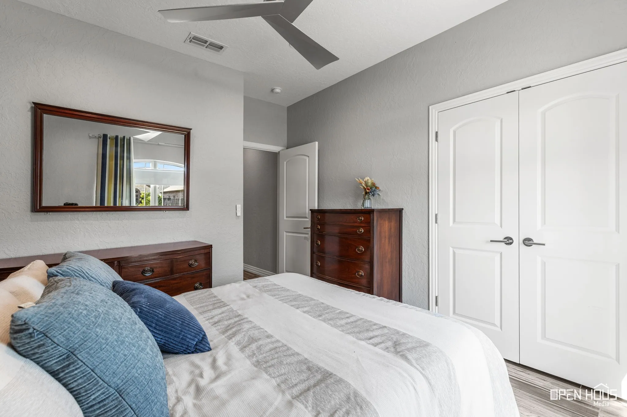 Tile flooring, ceiling fan, and white paneled doors