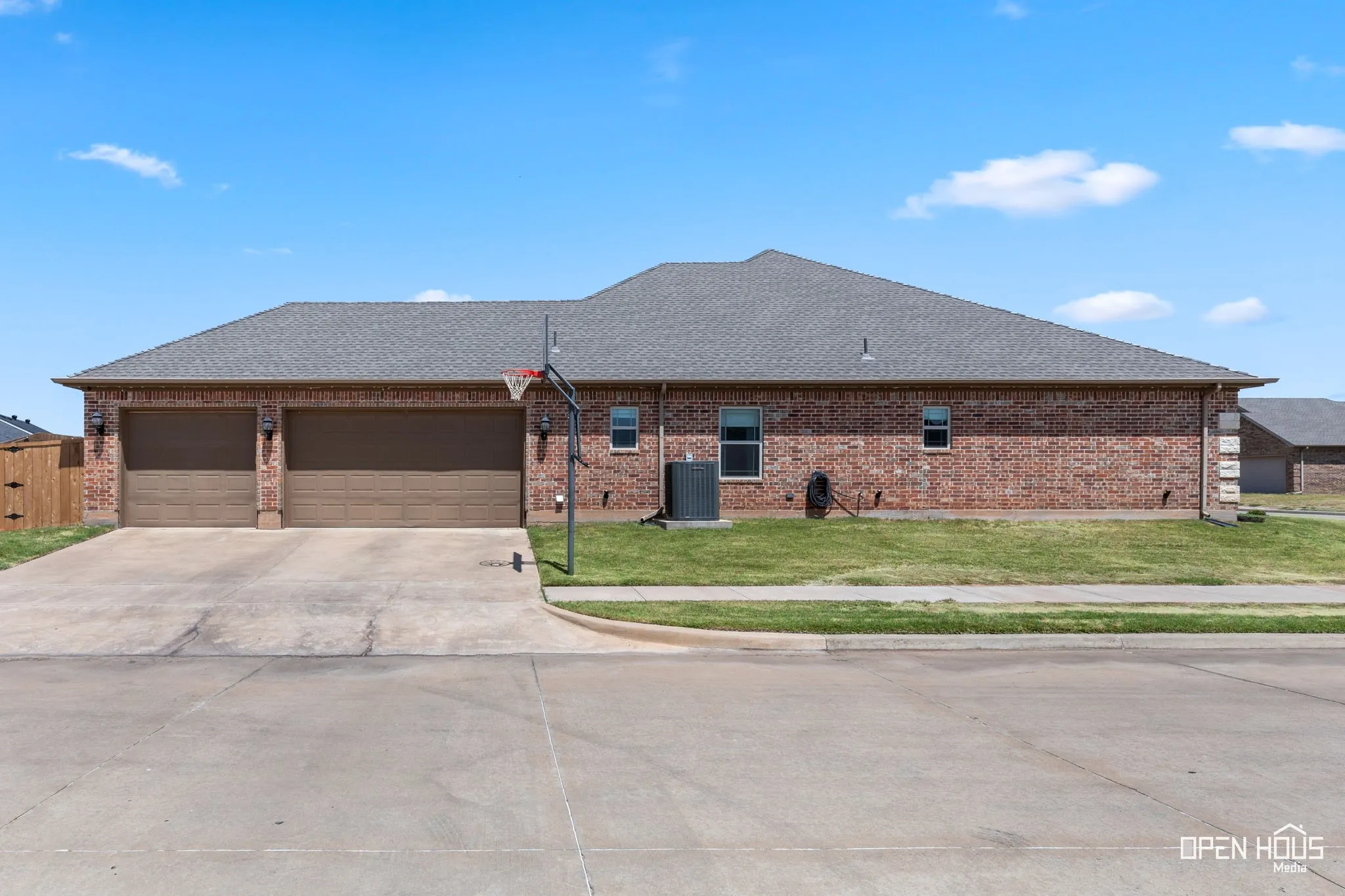 Three-car side-entry garage with EV plug