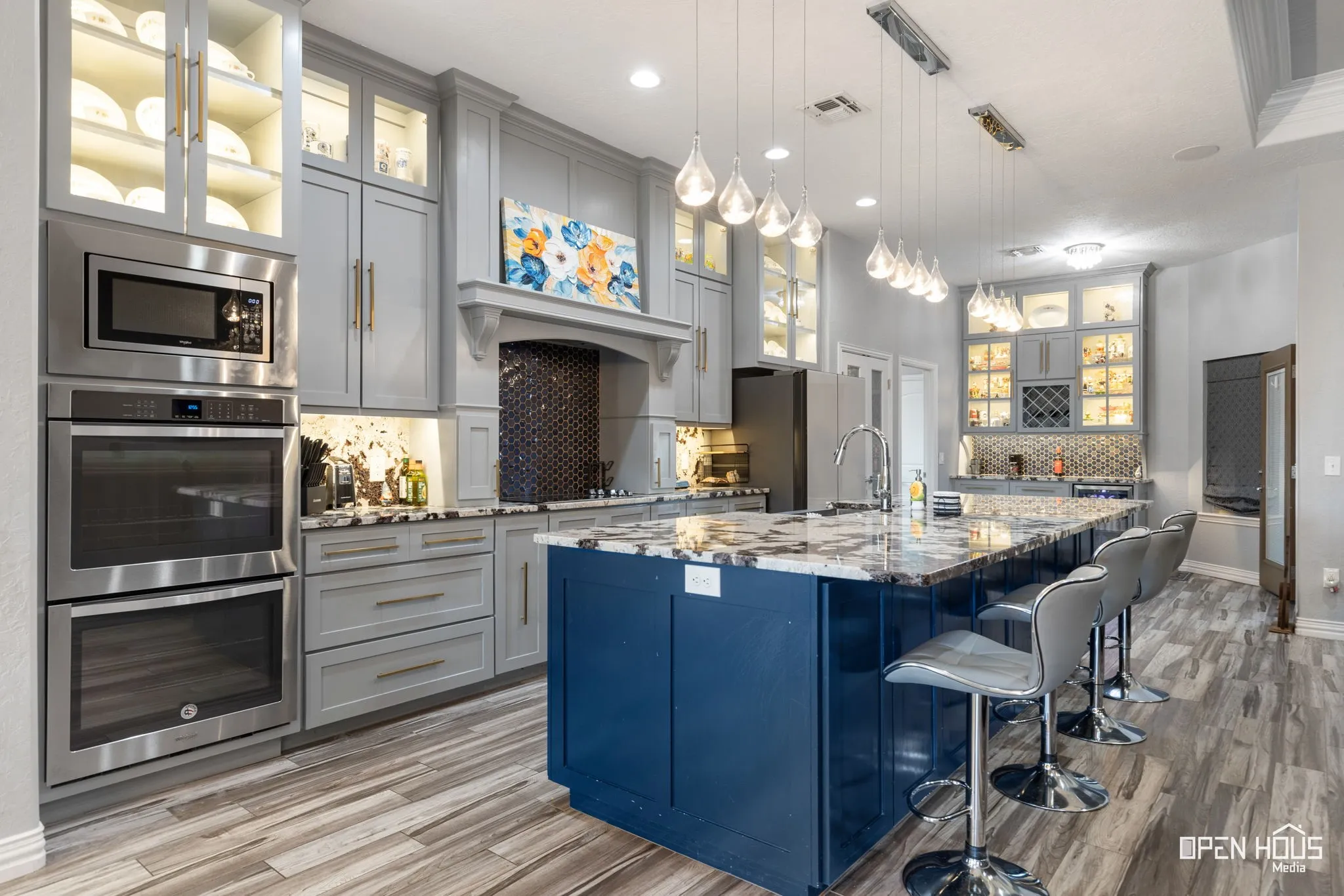 Spacious kitchen with a central island, tile flooring, recessed lighting, and stainless steel appliances