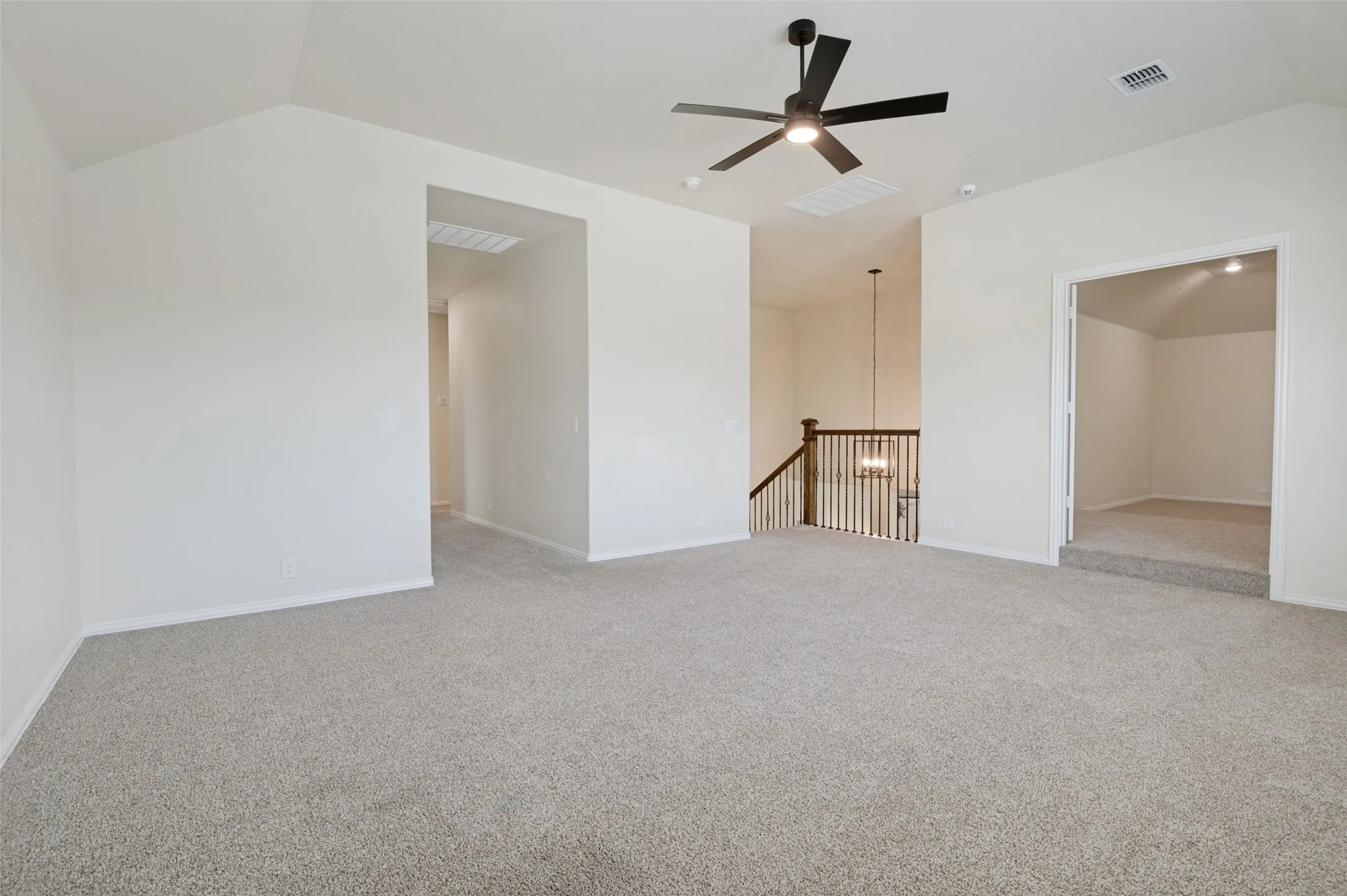Vaulted ceiling with a black ceiling fan, recessed lighting, and light-toned carpet flooring