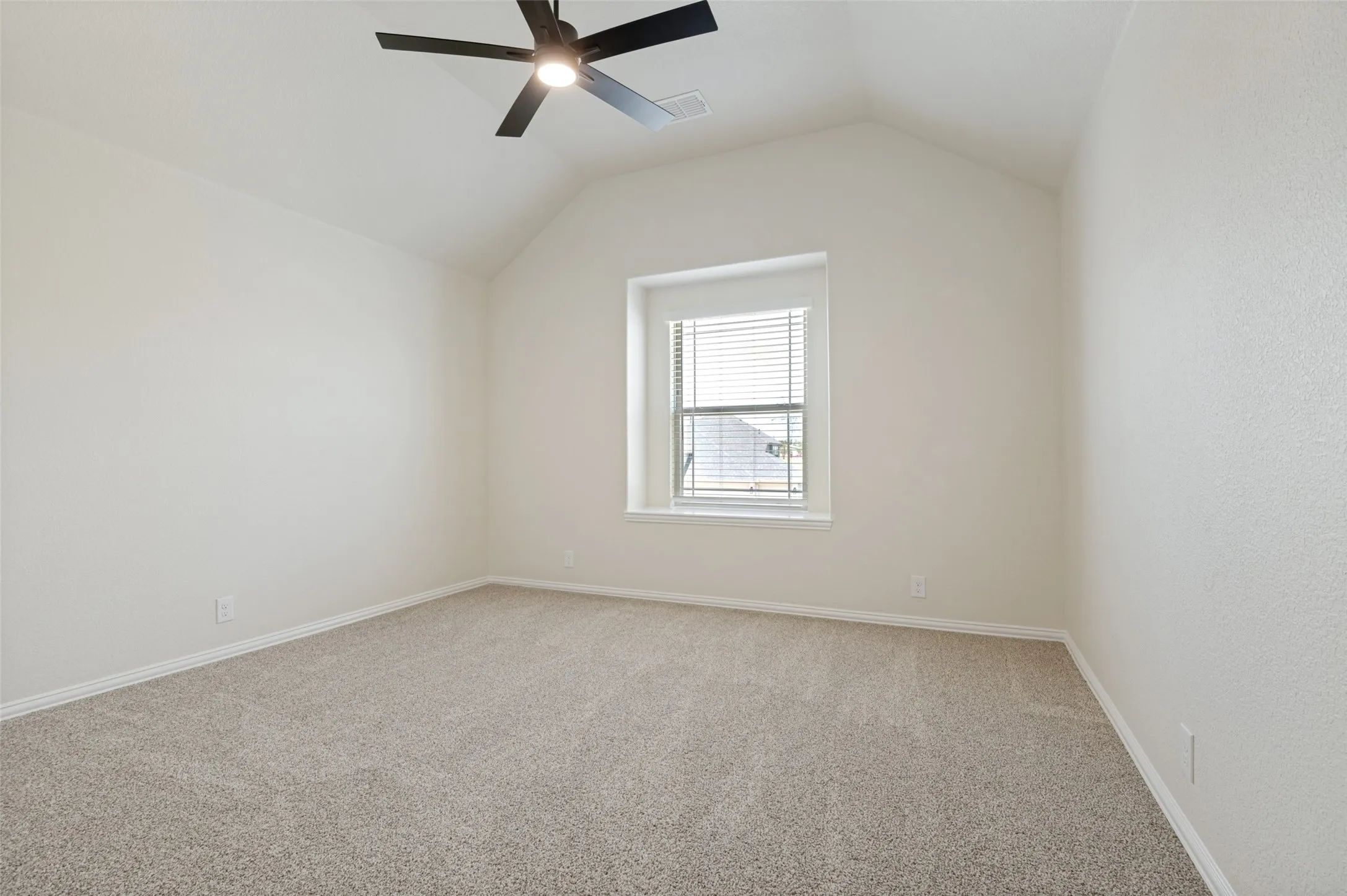 Vaulted ceiling with a ceiling fan, neutral carpet, and a window with blinds