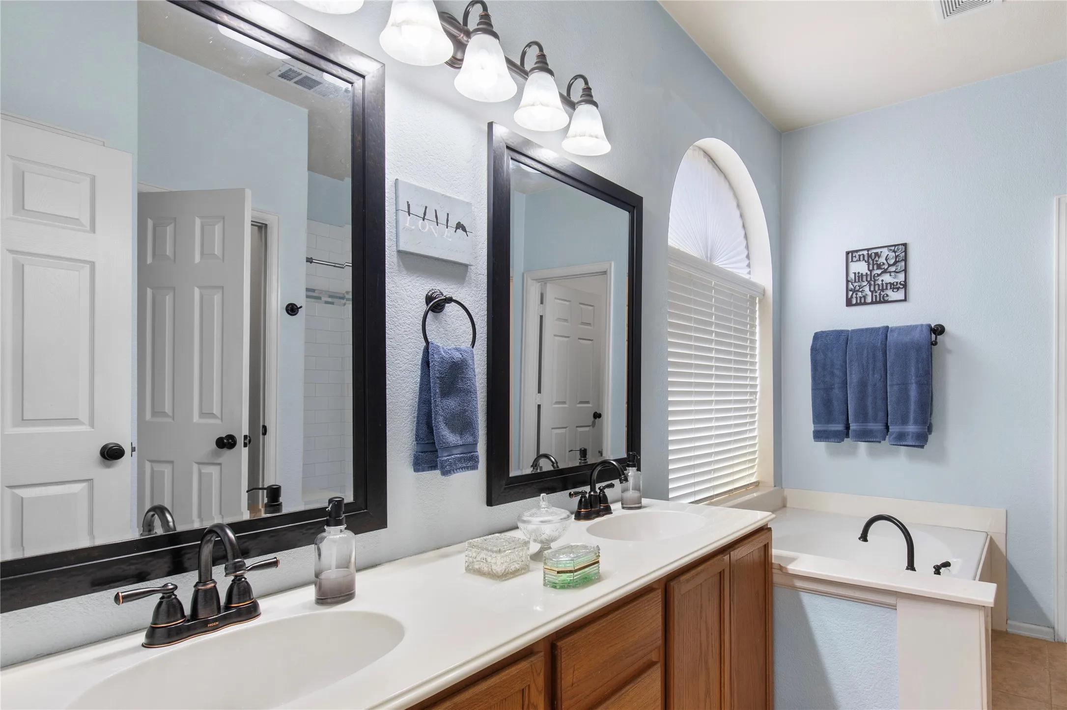 Dual vanity, garden tub, and oversized window
