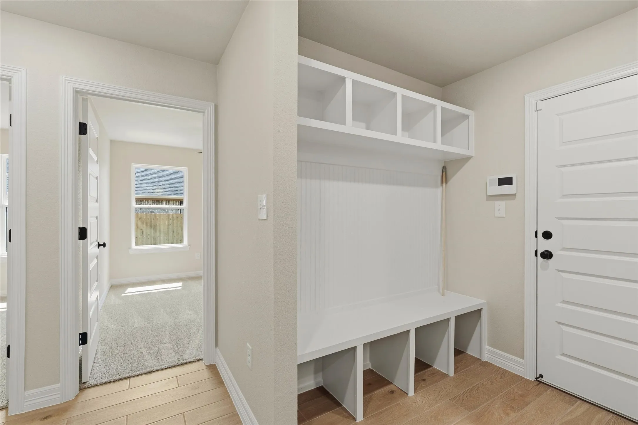 Built-in mudroom bench with cubby storage and upper shelving