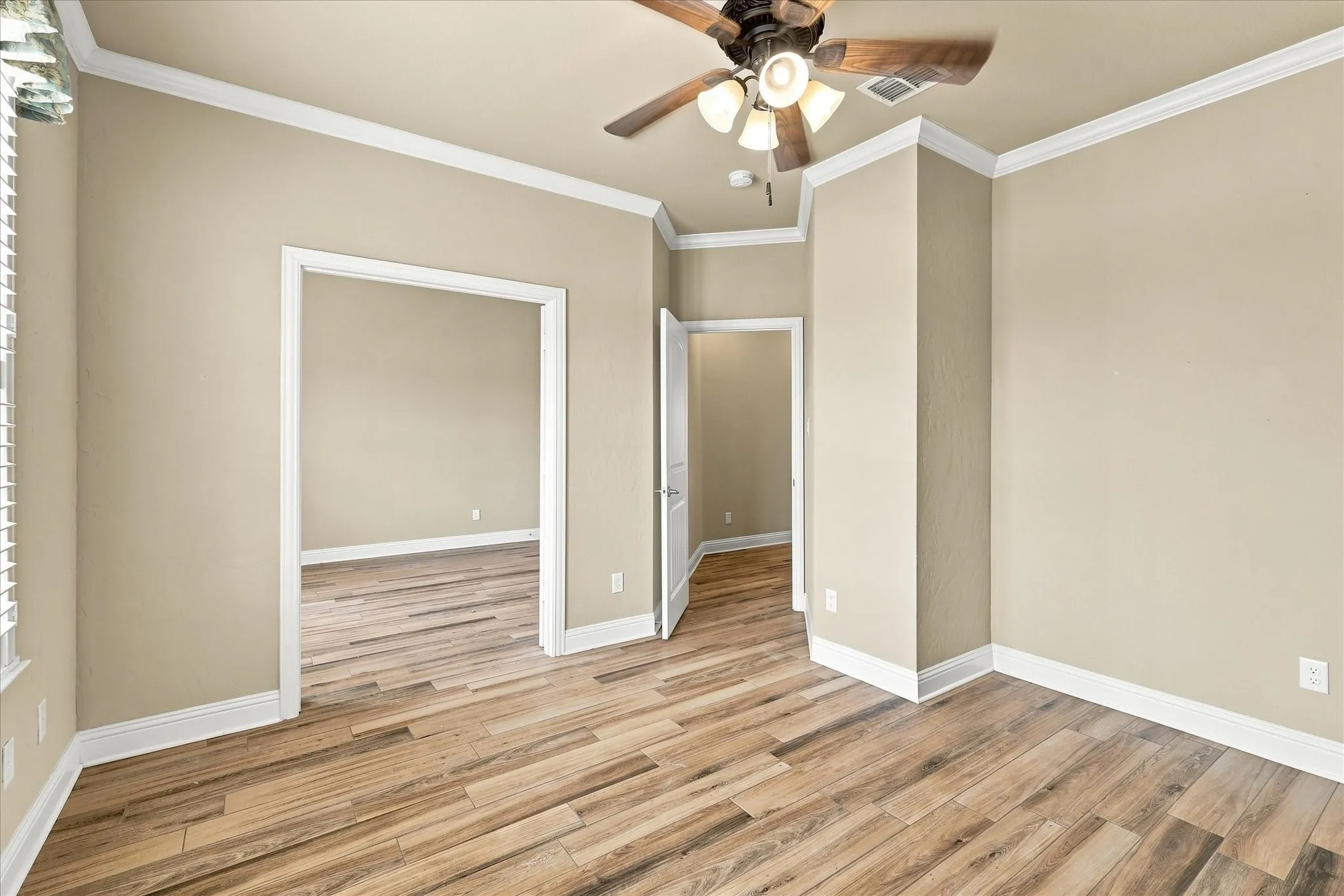 Bedroom 2 with an opening into bedroom 3 which was being utilized as a living space for multigenerational living. Notice the alcove on the right of the image where owner kept a large wardrobe for storage but a closet could be added.