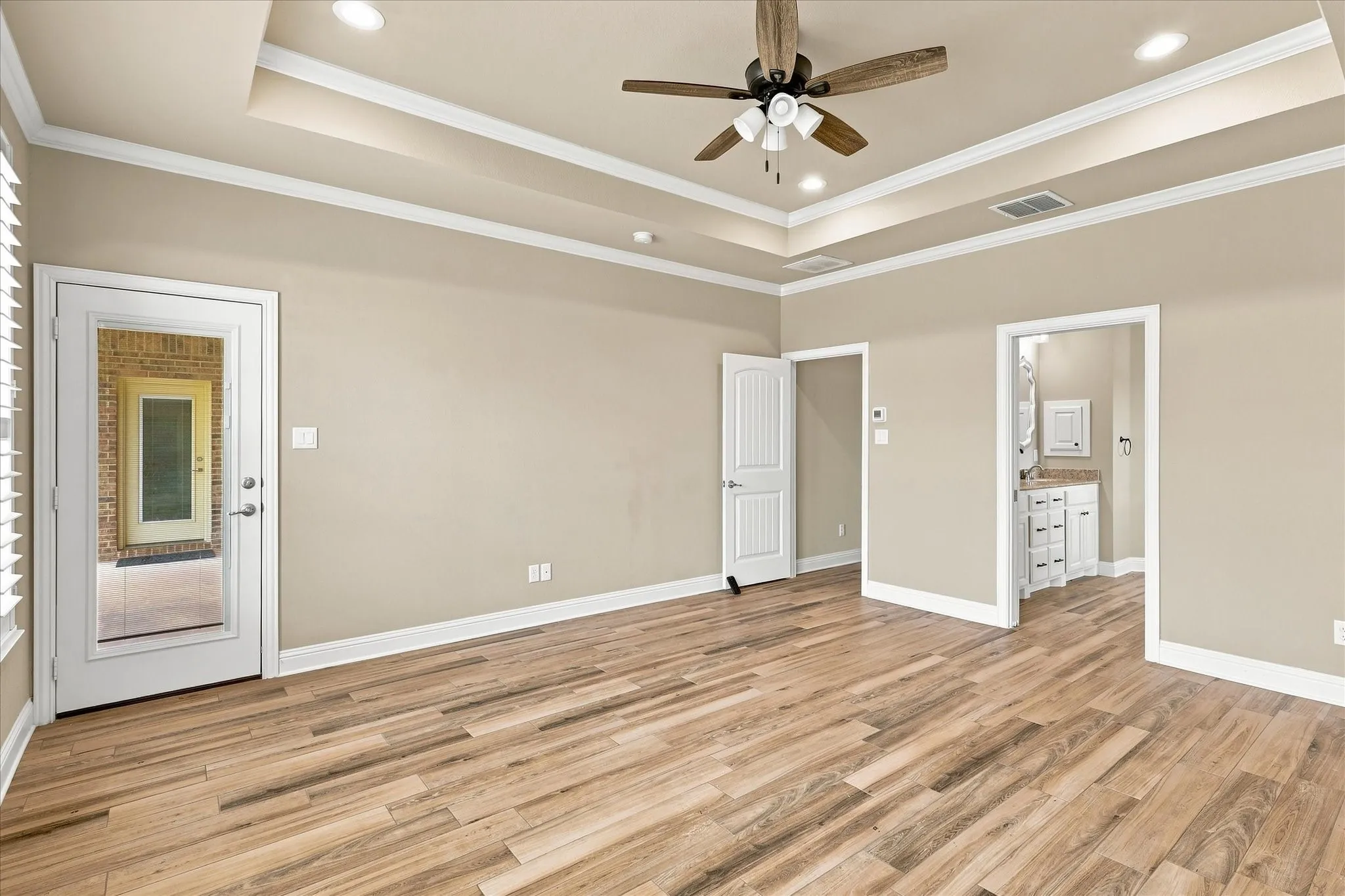 Primary bedroom has private access to the covered back patio.