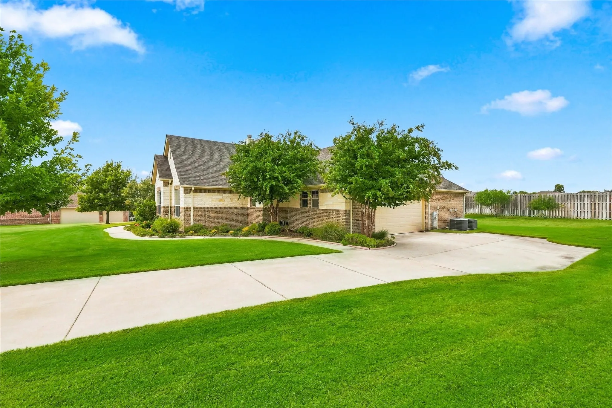 Side facing garage and long driveway with extra space for parking.