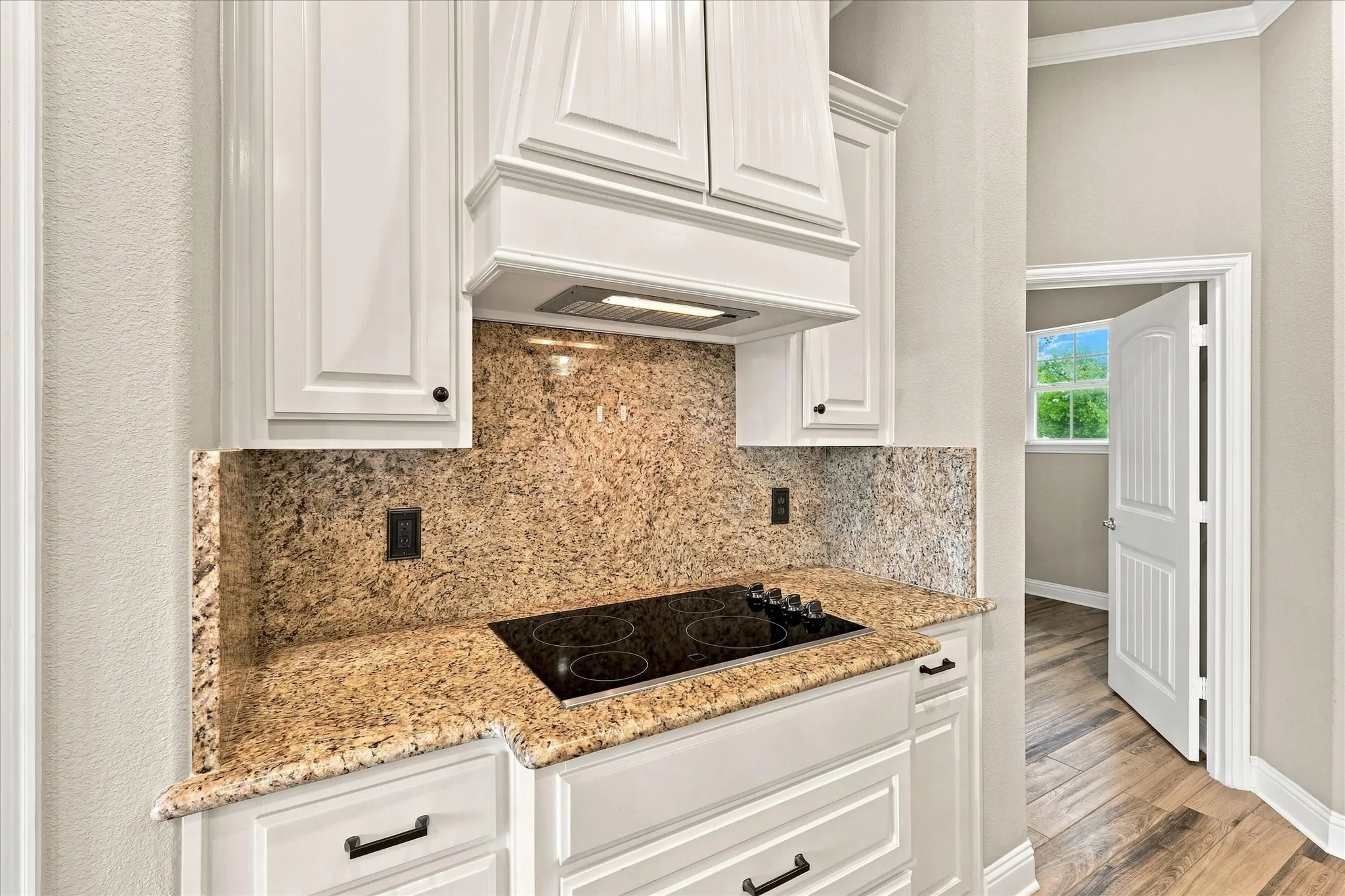 Electric cooktop with custom vent fan and outlets are BOTH sides for kitchen appliances and gadgets or holiday decorations.