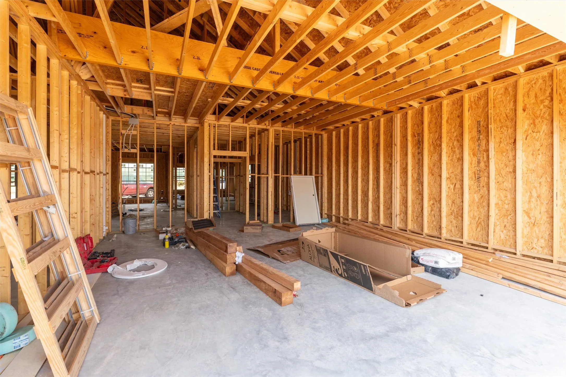 Interior framing featuring wood studs and ceiling joists