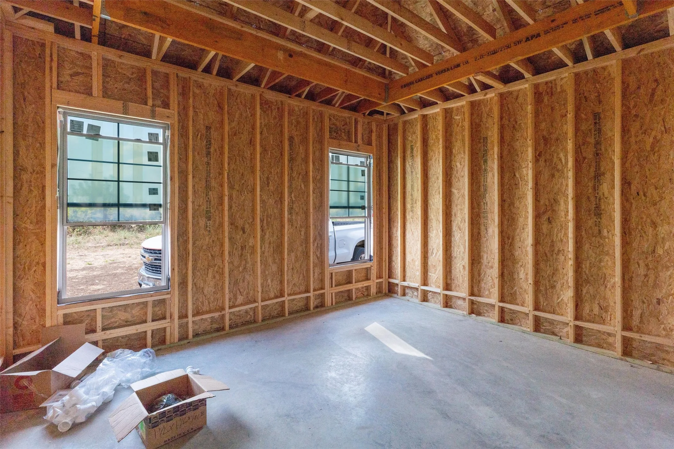 New construction with exposed wooden wall studs and roof trusses