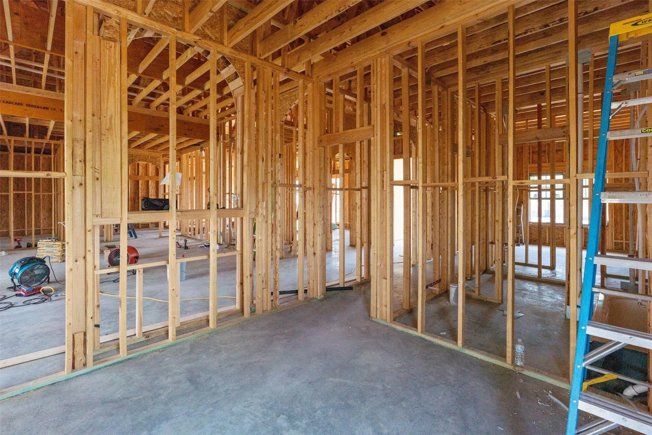 New construction framing with open stud walls and exposed ceiling joists