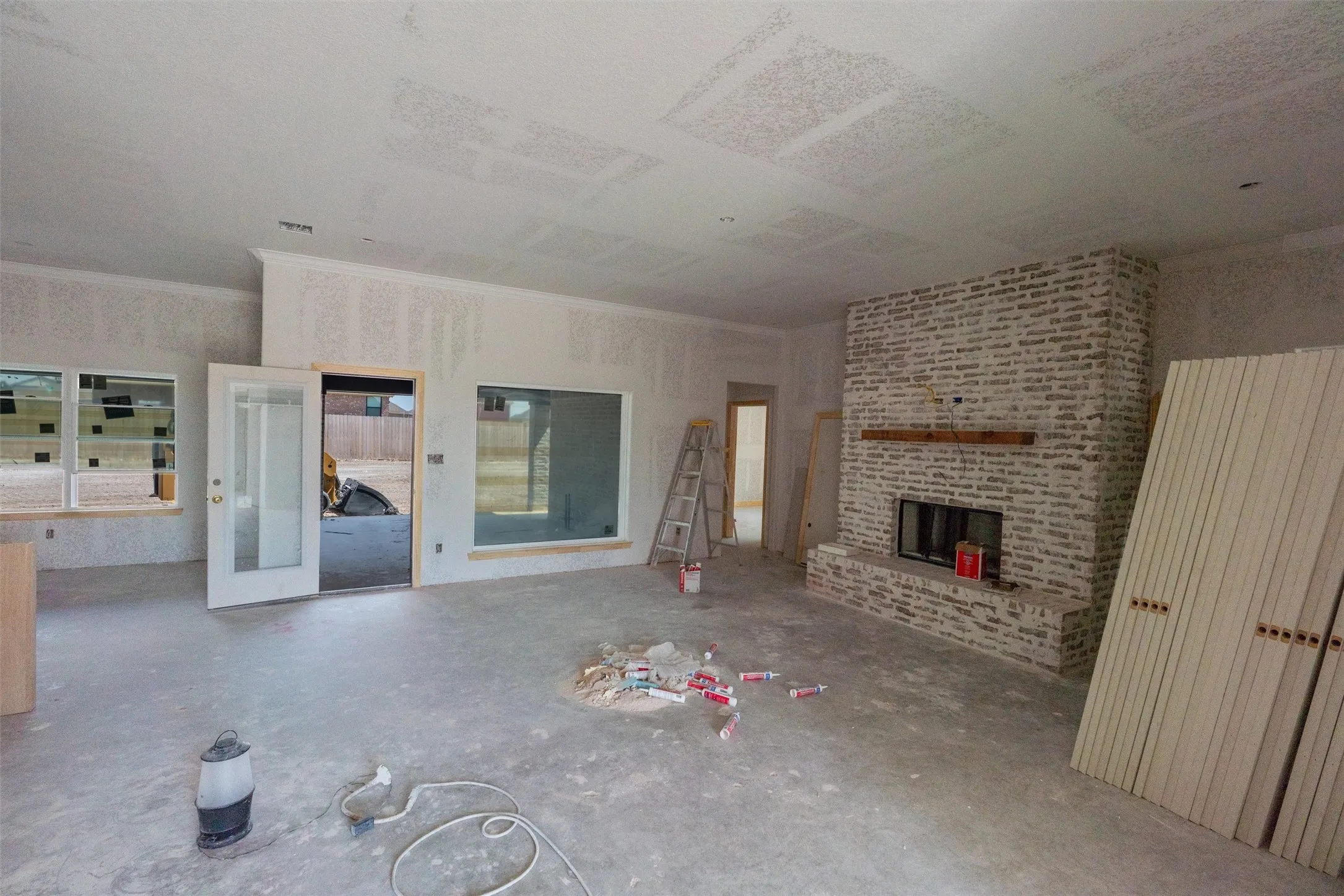 Stone veneer fireplace with a wood mantel
