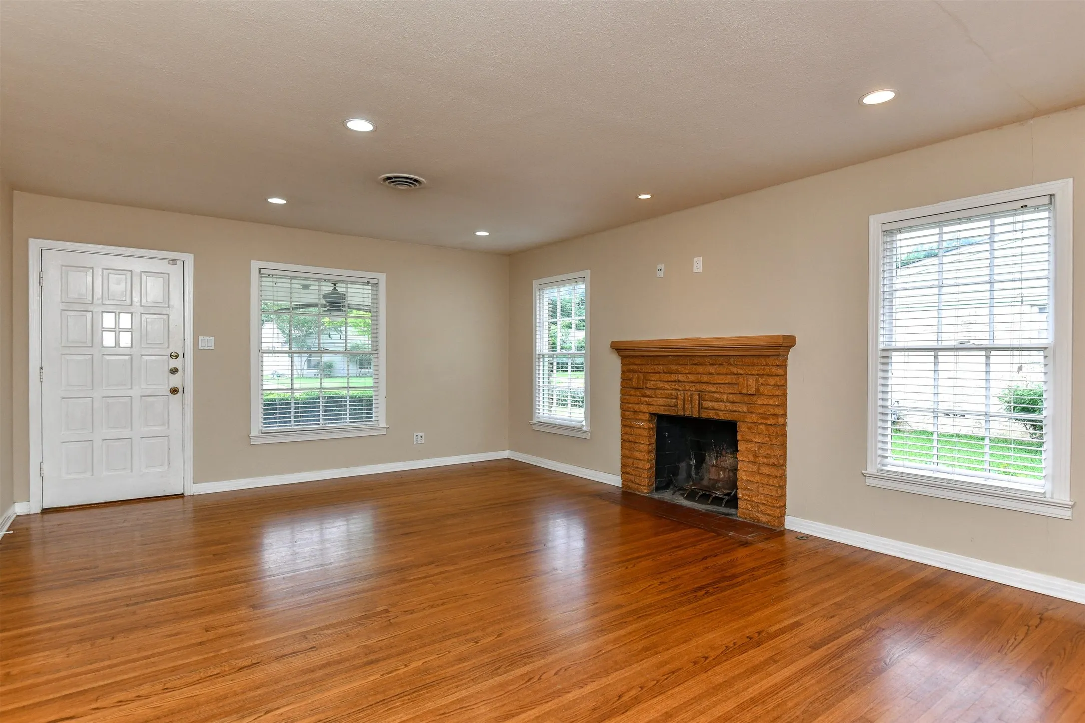 Unfurnished living room with a fireplace and hardwood / wood-style flooring