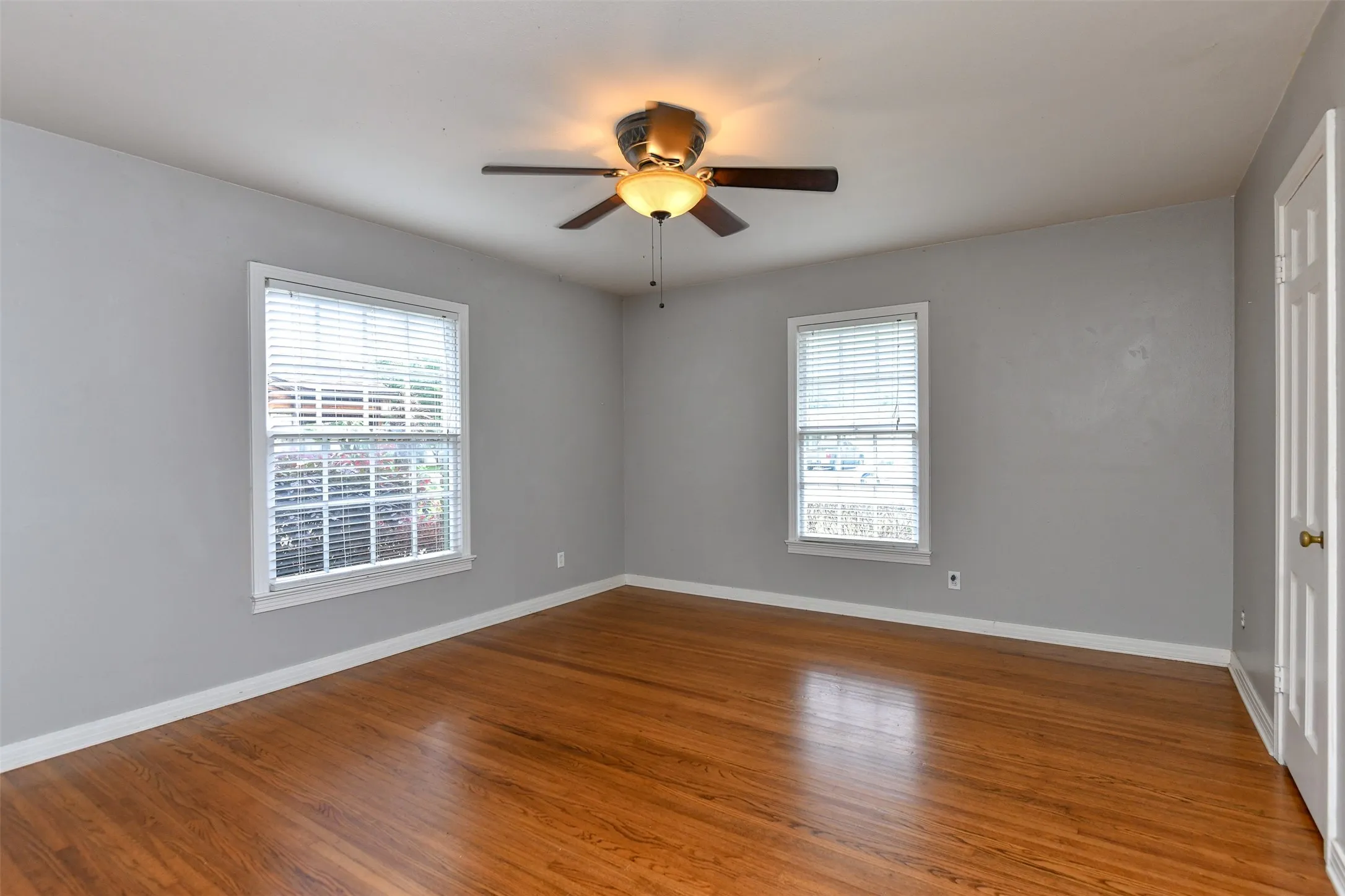 Unfurnished room featuring hardwood / wood-style flooring and ceiling fan