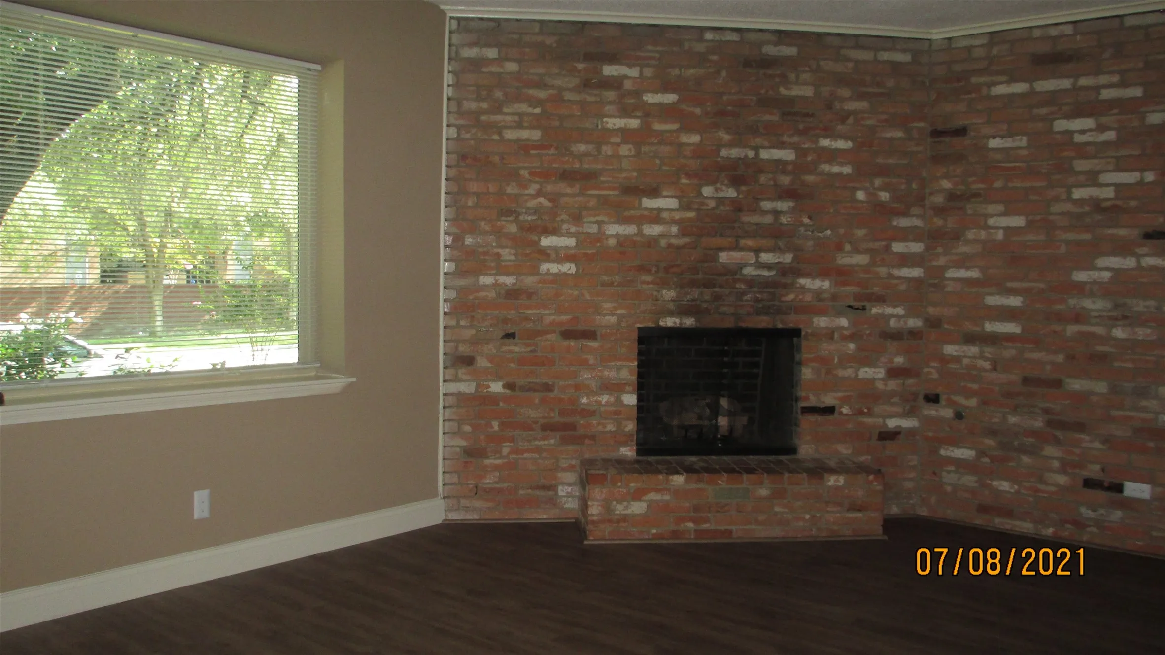 Fireplace wall and large window in living room