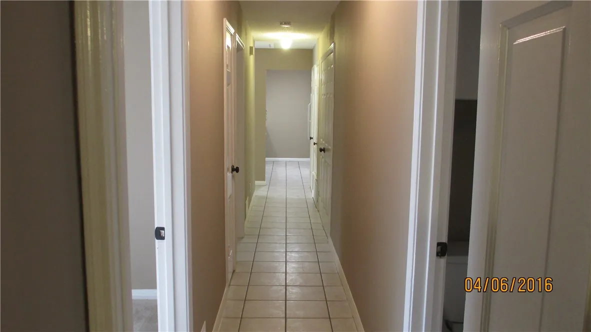 Long hallway leading back to the kitchen