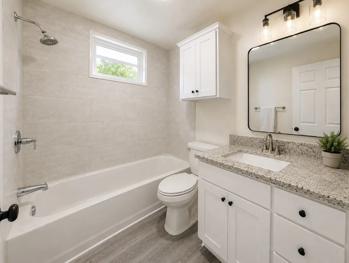 White vanity with granite-finish countertop and undermount sink