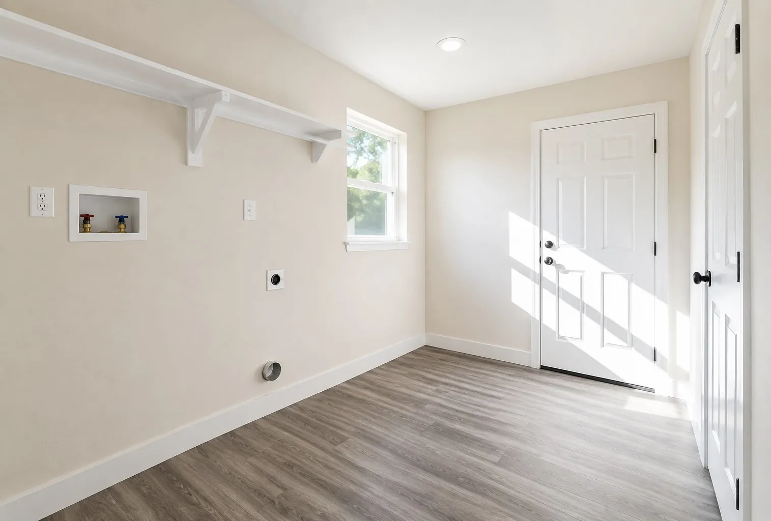 Laundry area featuring wood-finish flooring, white paneled doors, and built-in shelving