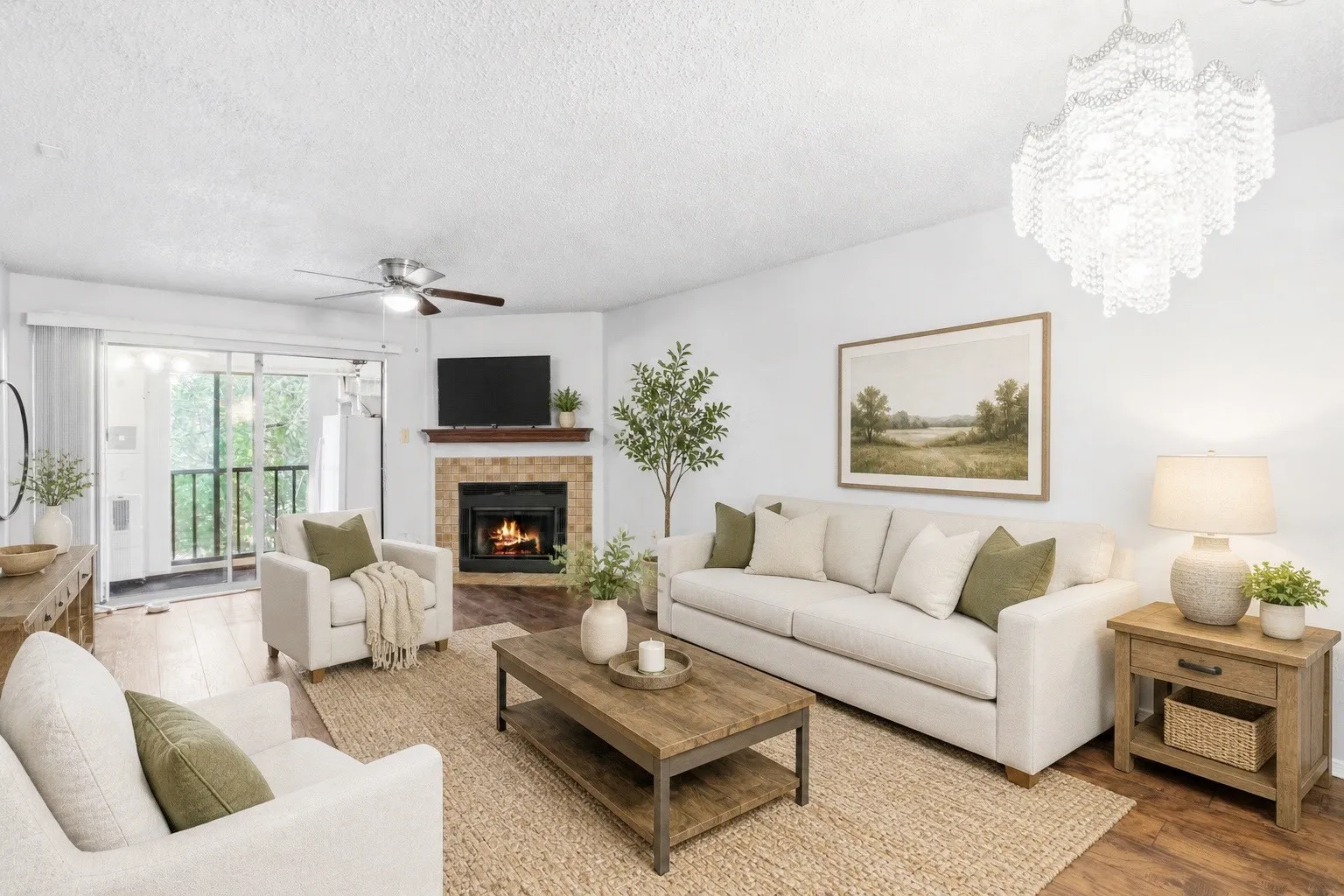 Living area featuring wood-finish flooring, a fireplace with a stone surround and wood mantel, a ceiling fan, and sliding glass doors to a balcony