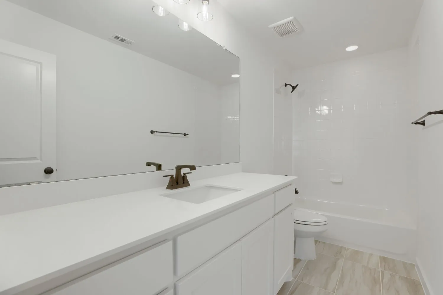 White vanity with undermount sink and oil-rubbed bronze faucet