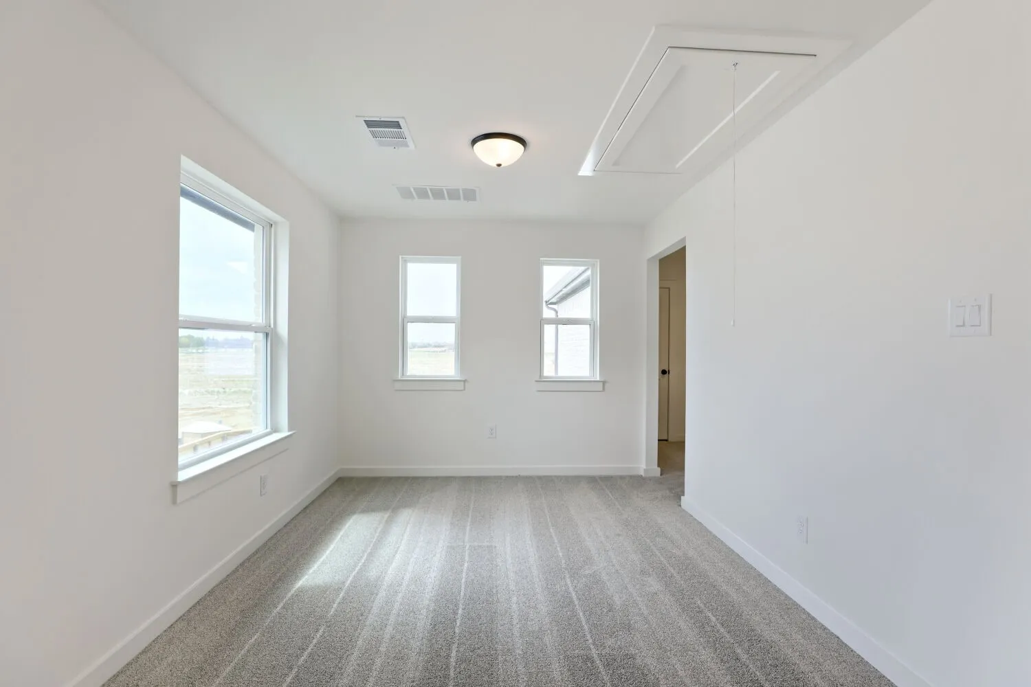 Adjoining card room with multiple windows, and a ceiling-mounted light fixture