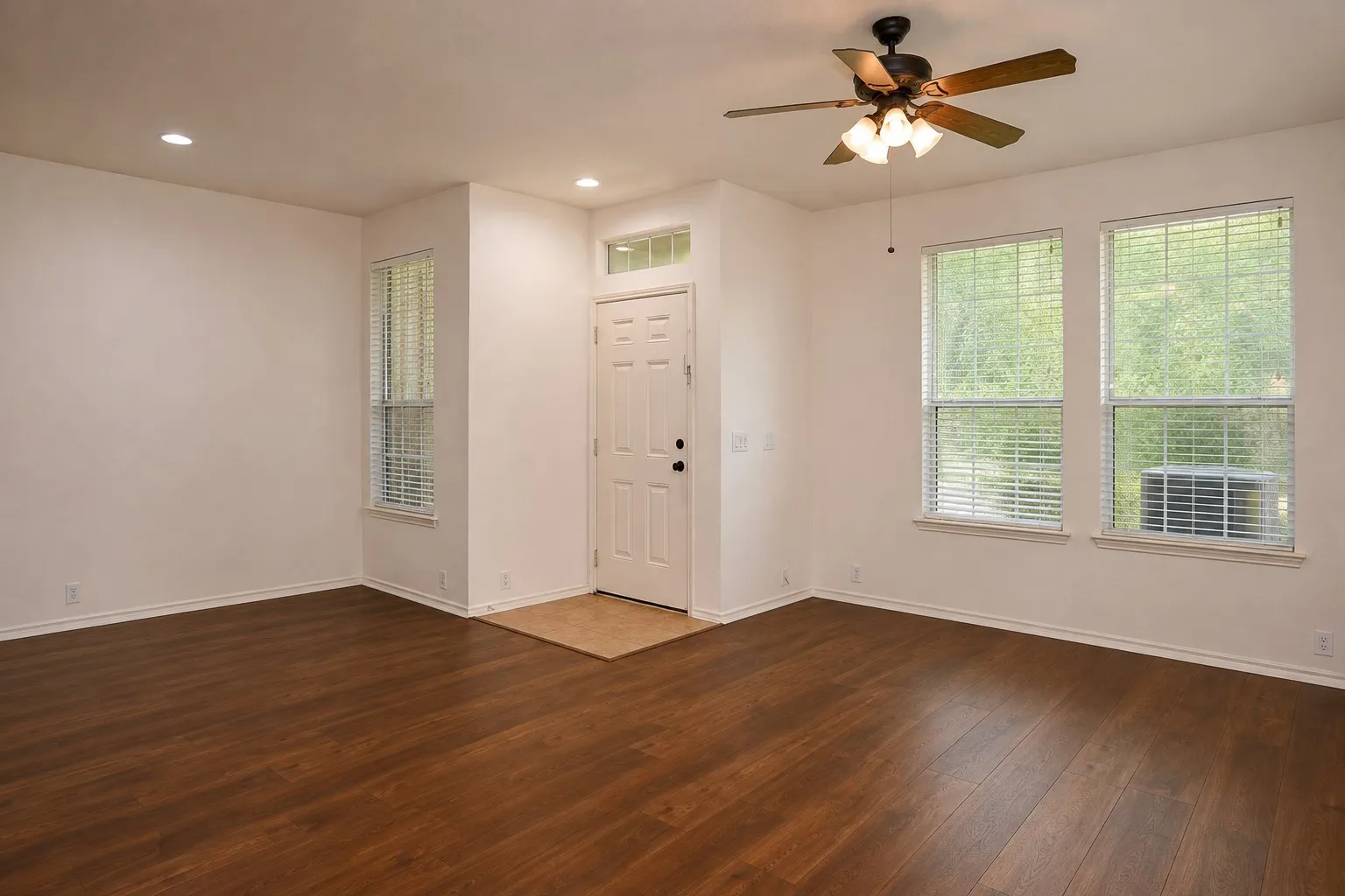 Wood-finish flooring throughout, recessed lighting, and a ceiling fan with integrated lighting