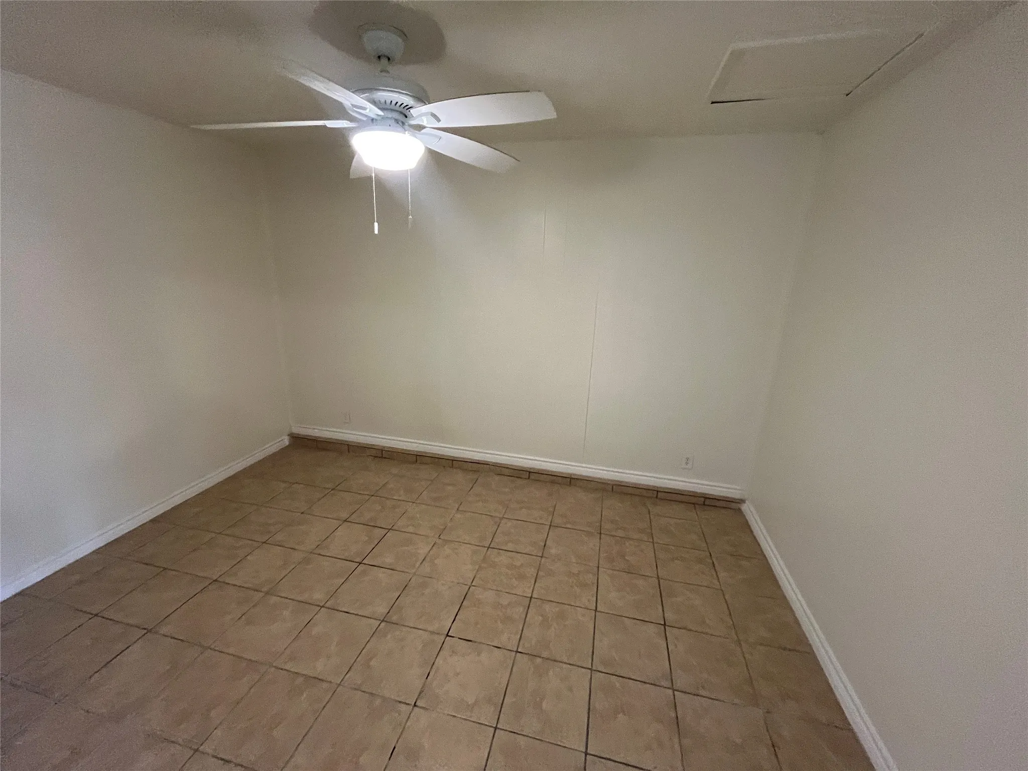 Ceramic tile flooring, neutral wall tones, and ceiling fan with integrated lighting