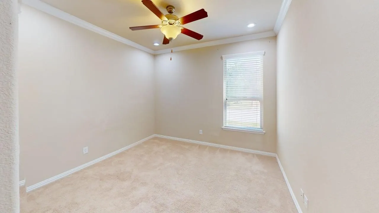 Recessed lighting, crown molding, ceiling fan with light fixture, window with blinds, and neutral carpet flooring
