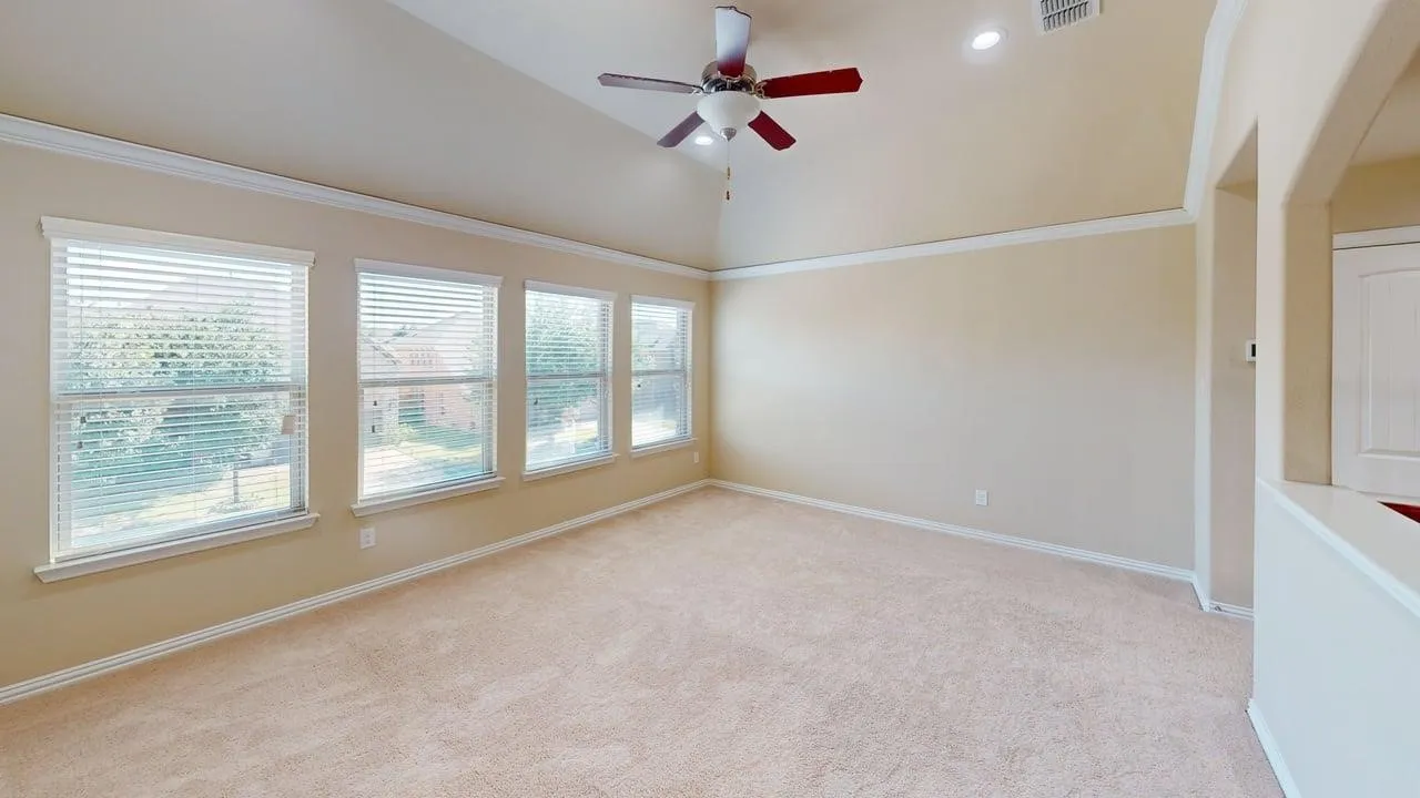 Vaulted ceiling with a ceiling fan, recessed lighting, carpet flooring, and multiple windows with blinds