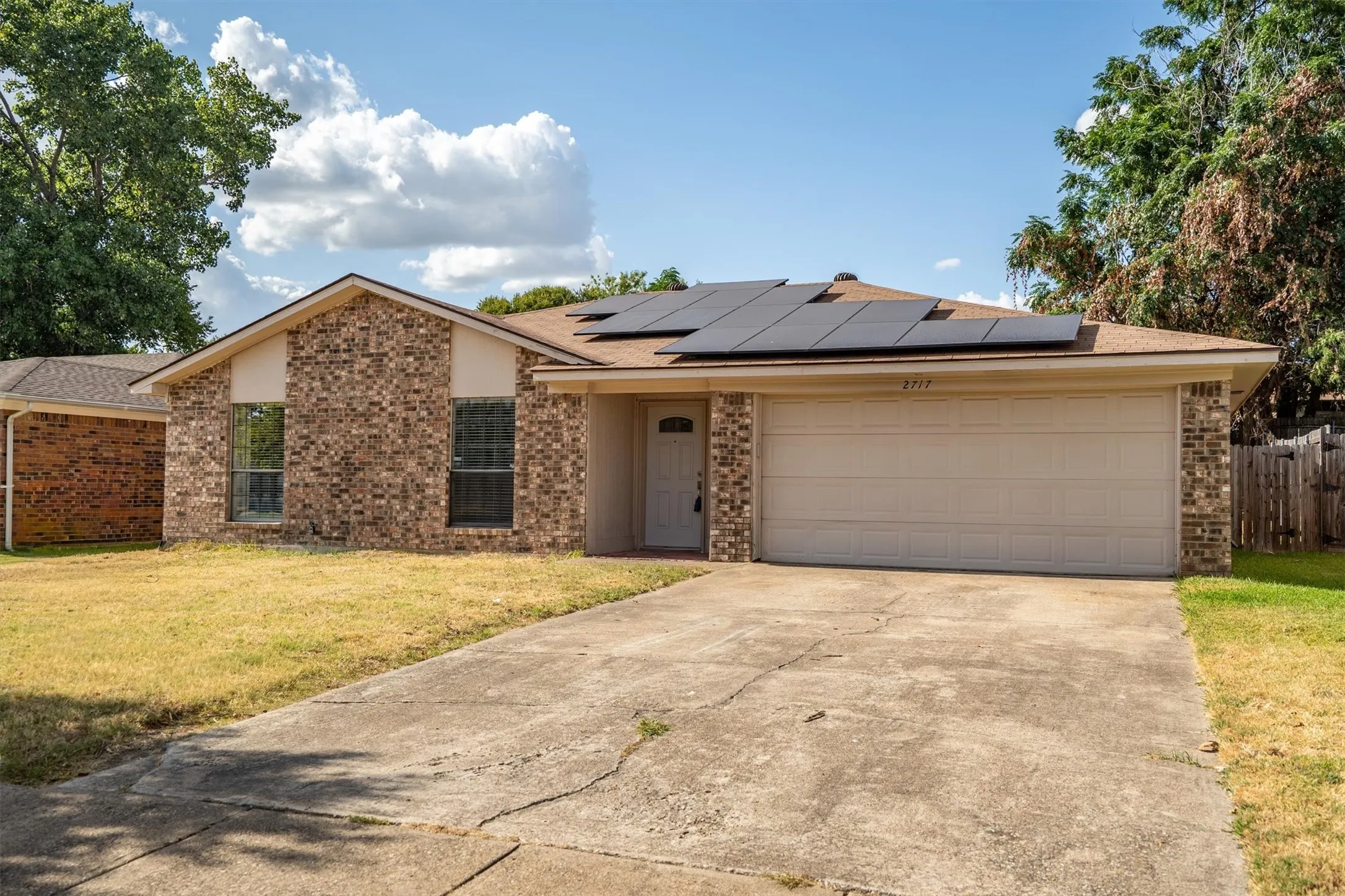 Brick exterior with a gabled roof and integrated solar panels